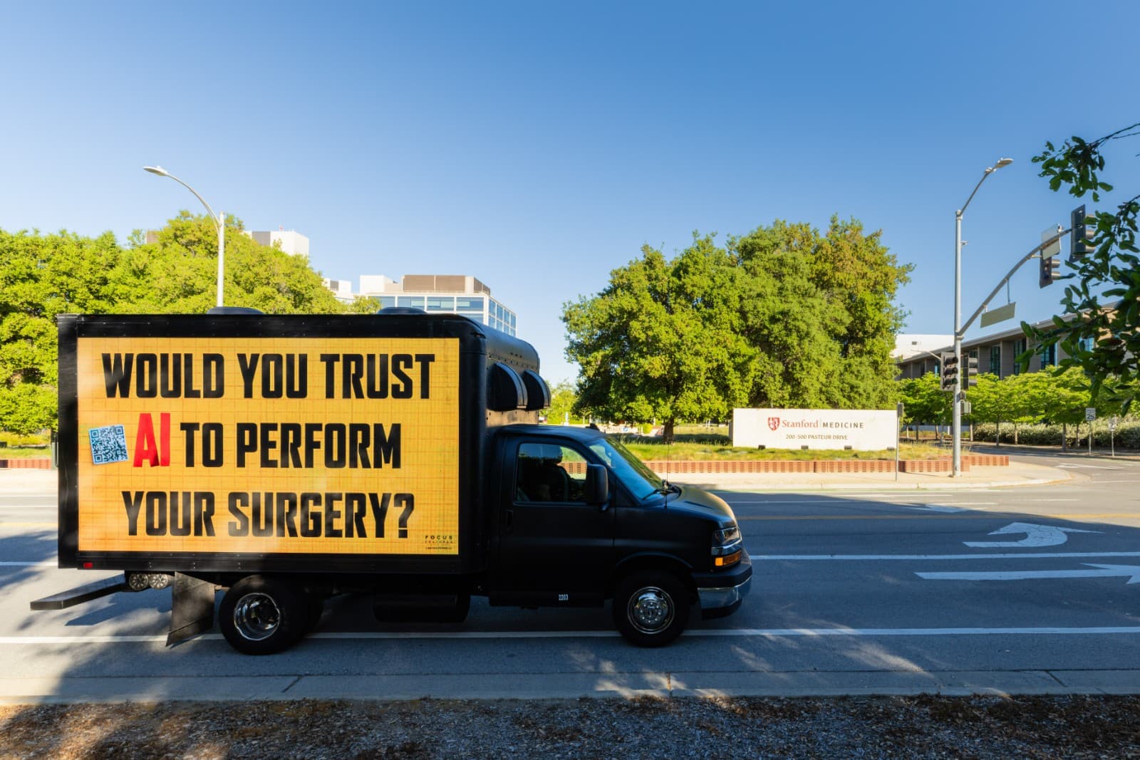 The AI Doc LED truck illuminated at dusk outside tech company campus in Silicon Valley by JY Studio