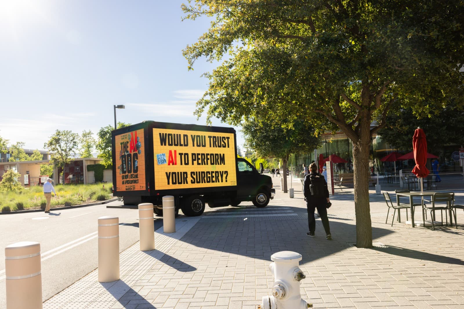 Wide shot of The AI Doc promotional truck at Stanford University entrance Palo Alto by JY Studio