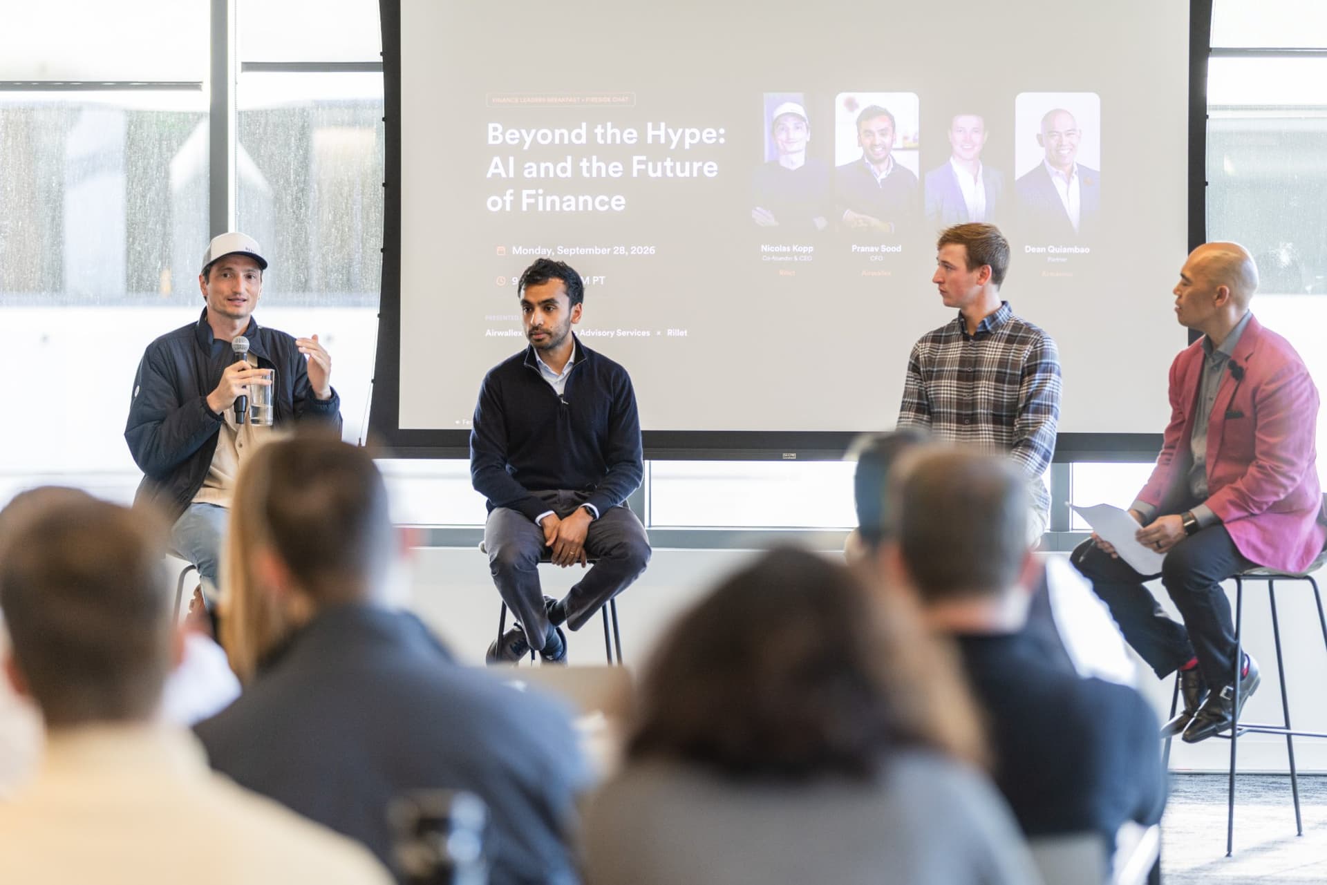 Nicolas Kopp, Co-founder and CEO of Rillet, speaking with a microphone on stage at Airwallex's Beyond the Hype: AI and the Future of Finance breakfast fireside chat at the Airwallex San Francisco office by JY Studio
