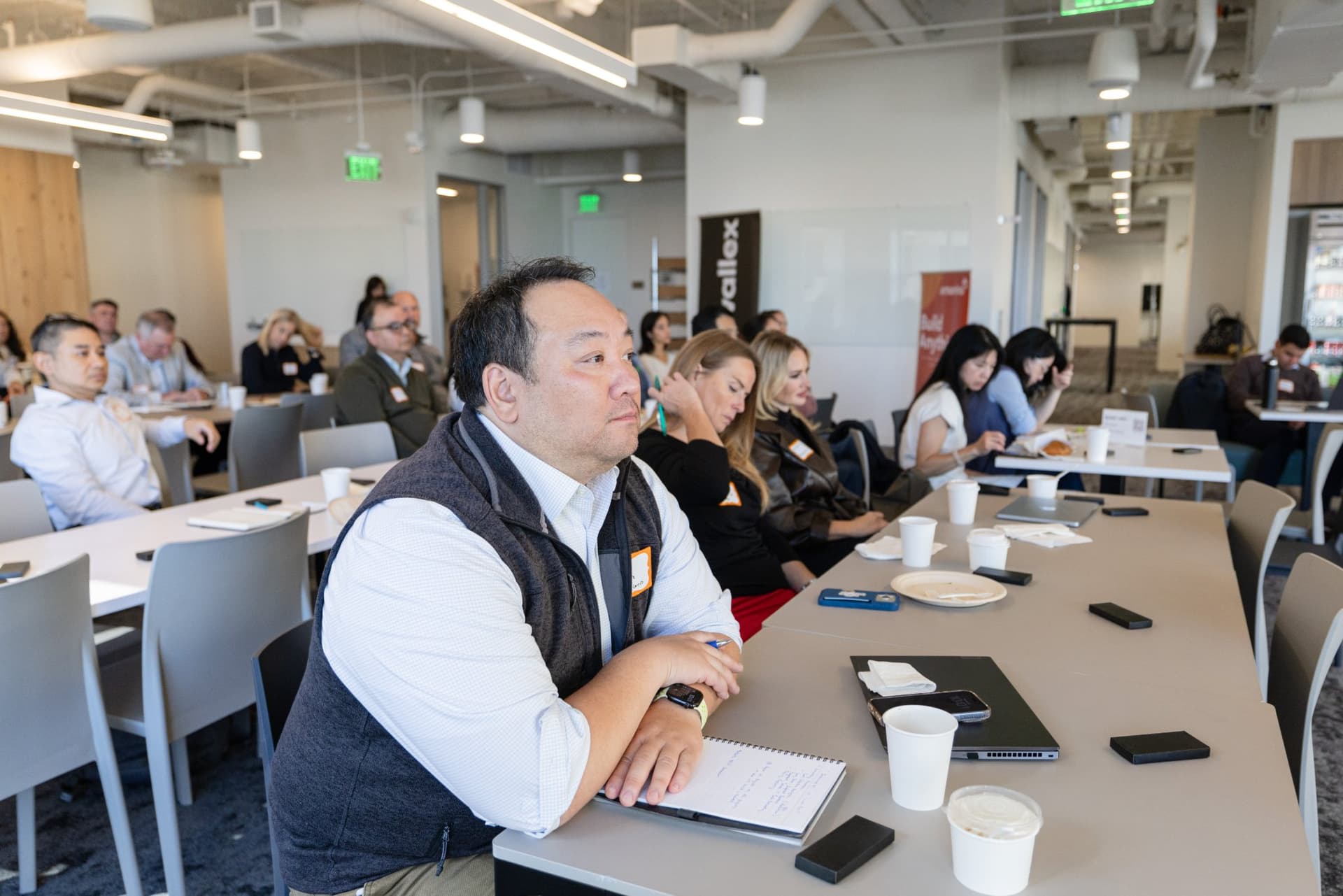 Finance leader taking notes during the fireside chat at Airwallex's Beyond the Hype: AI and the Future of Finance breakfast fireside chat at the Airwallex San Francisco office by JY Studio