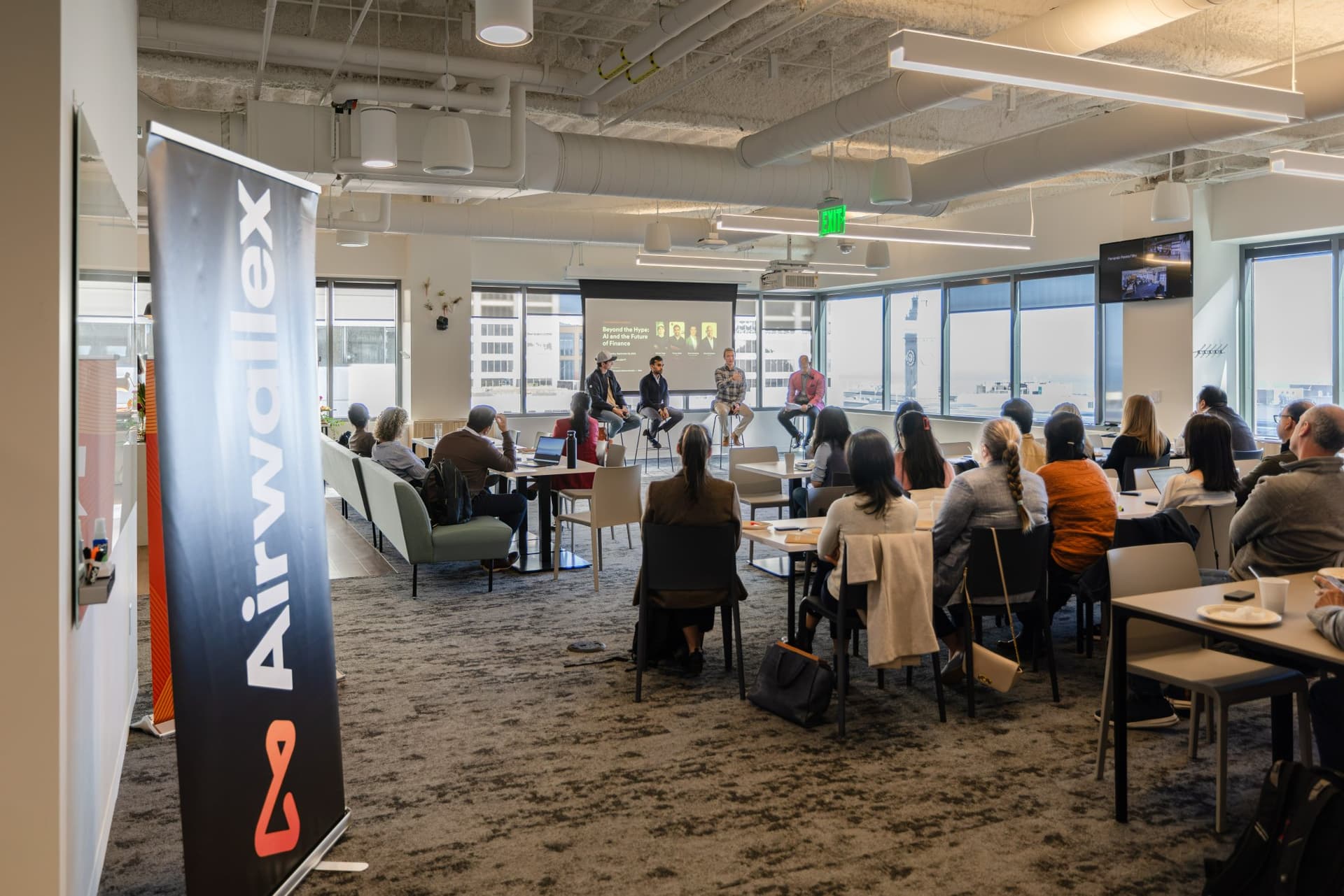 Airwallex pull-up banner in the foreground of the fireside chat at Airwallex's Beyond the Hype: AI and the Future of Finance breakfast fireside chat at the Airwallex San Francisco office by JY Studio
