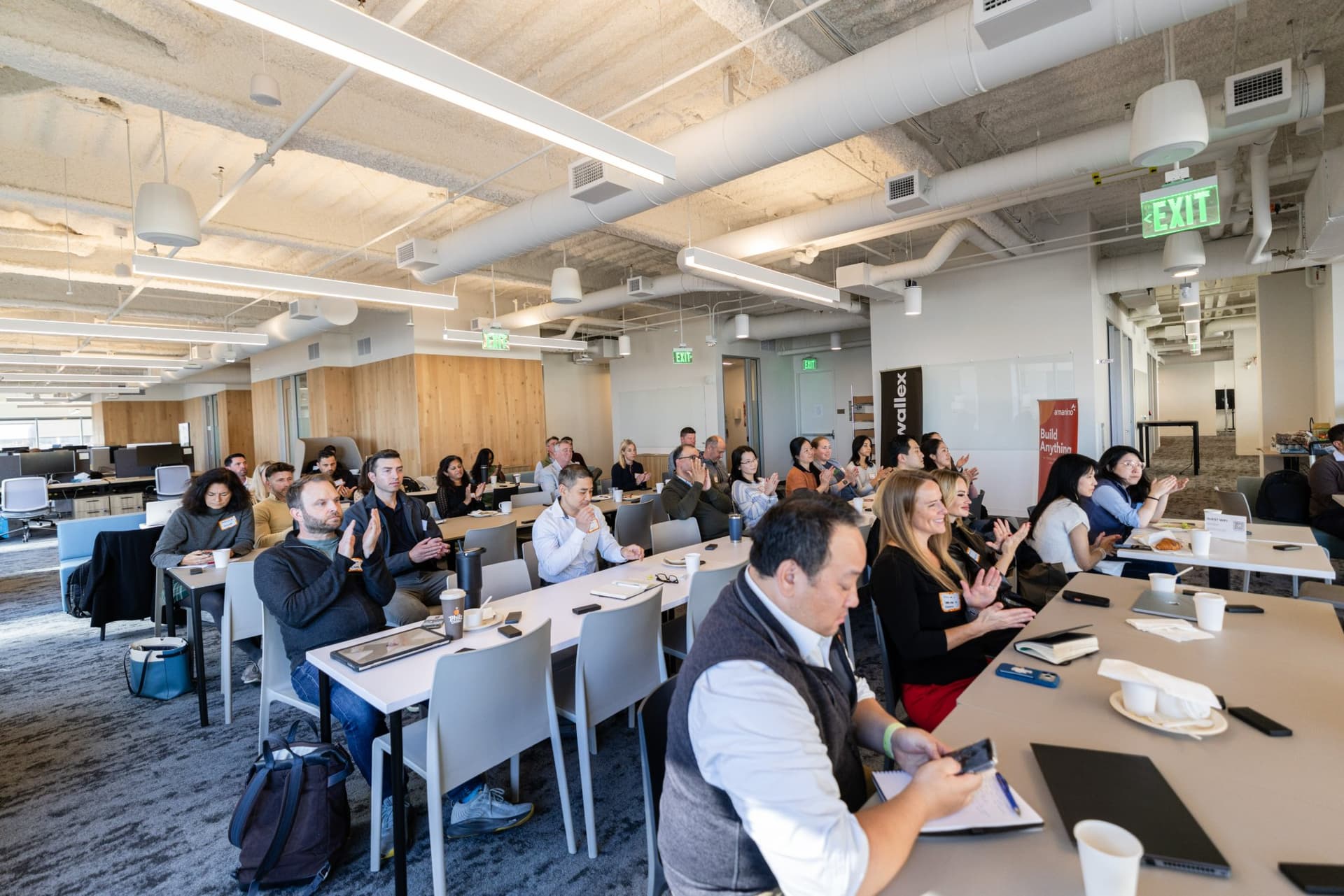 Room full of finance leaders listening to the AI and finance discussion at Airwallex's Beyond the Hype: AI and the Future of Finance breakfast fireside chat at the Airwallex San Francisco office by JY Studio