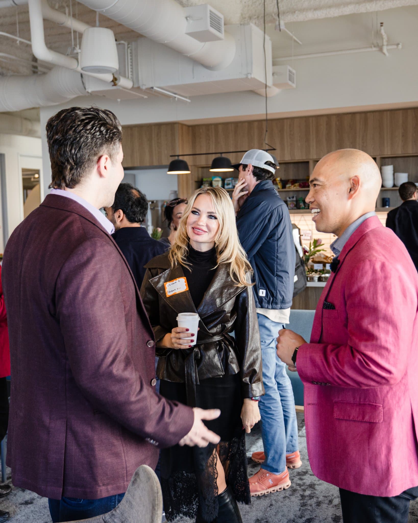 Moderator Dean Quiambao of Armanino chatting with guests after the panel at Airwallex's Beyond the Hype: AI and the Future of Finance breakfast fireside chat at the Airwallex San Francisco office by JY Studio