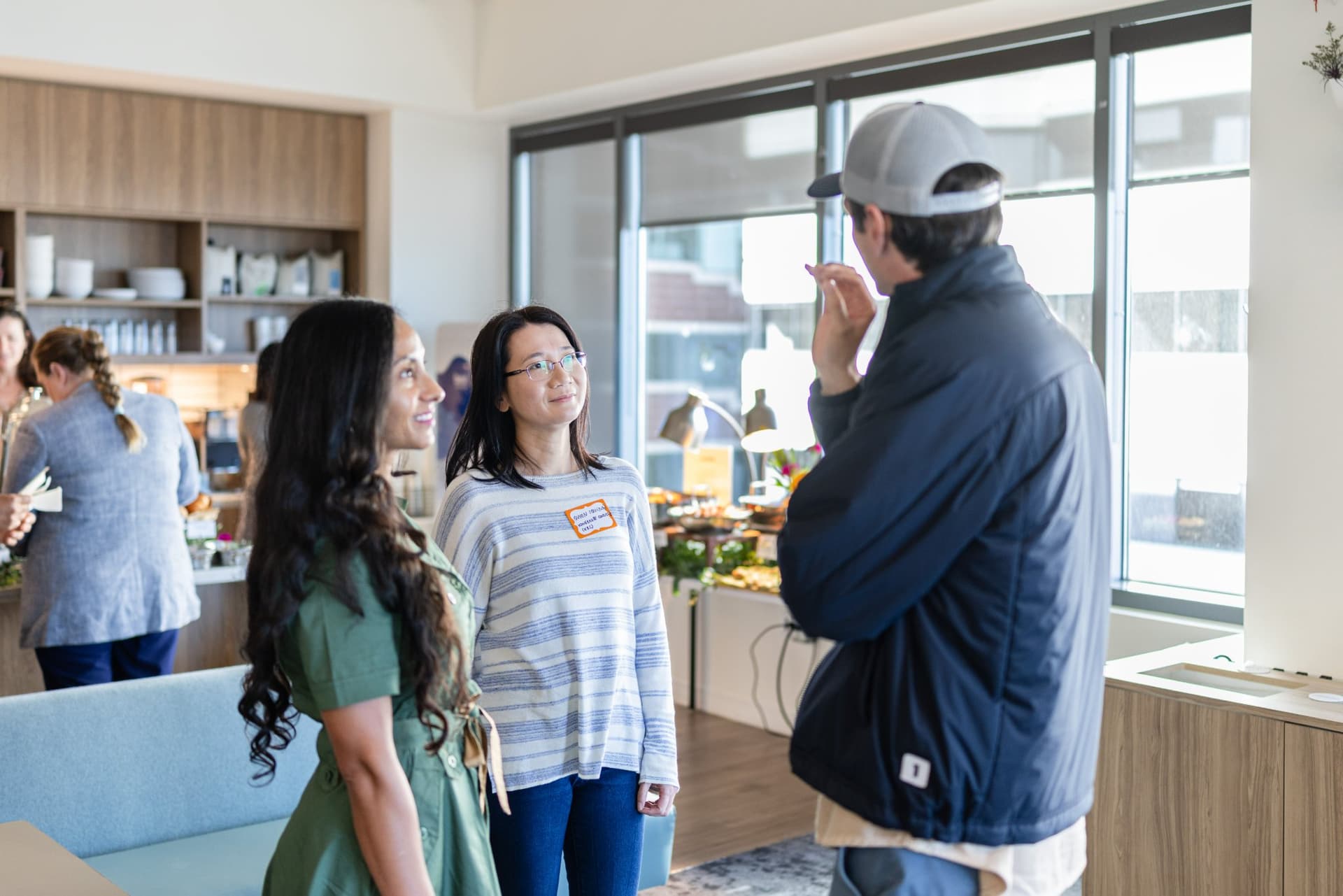 Nicolas Kopp talking with guests by the breakfast spread at Airwallex's Beyond the Hype: AI and the Future of Finance breakfast fireside chat at the Airwallex San Francisco office by JY Studio
