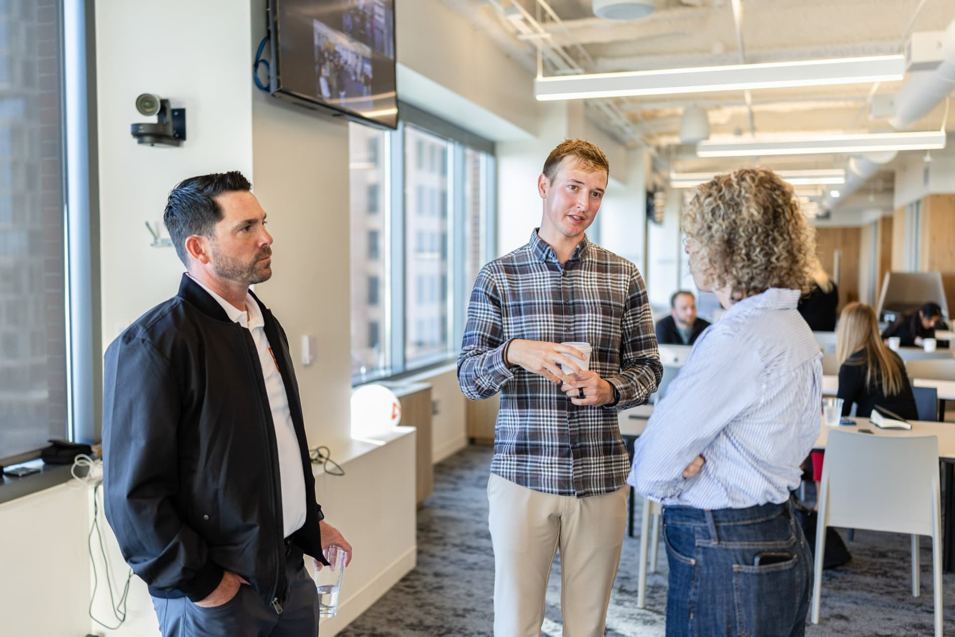 Drew Armanino talking with guests over coffee at Airwallex's Beyond the Hype: AI and the Future of Finance breakfast fireside chat at the Airwallex San Francisco office by JY Studio