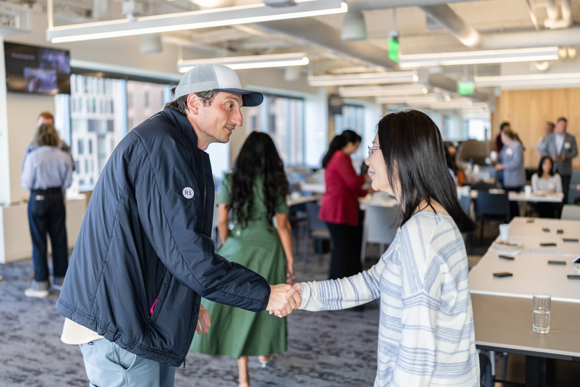 Nicolas Kopp shaking hands with an attendee at Airwallex's Beyond the Hype: AI and the Future of Finance breakfast fireside chat at the Airwallex San Francisco office by JY Studio