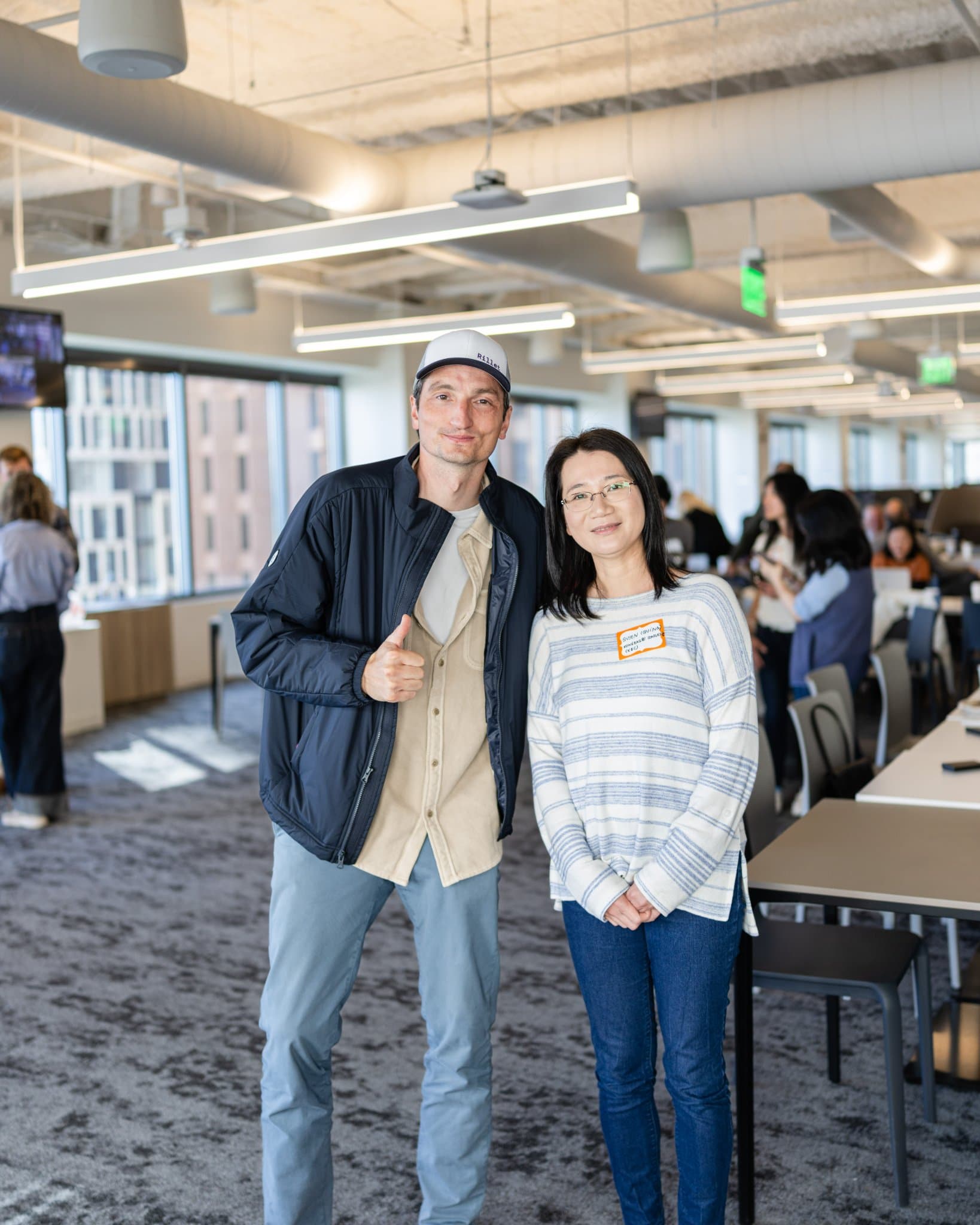 Nicolas Kopp giving a thumbs up in a photo with an attendee at Airwallex's Beyond the Hype: AI and the Future of Finance breakfast fireside chat at the Airwallex San Francisco office by JY Studio