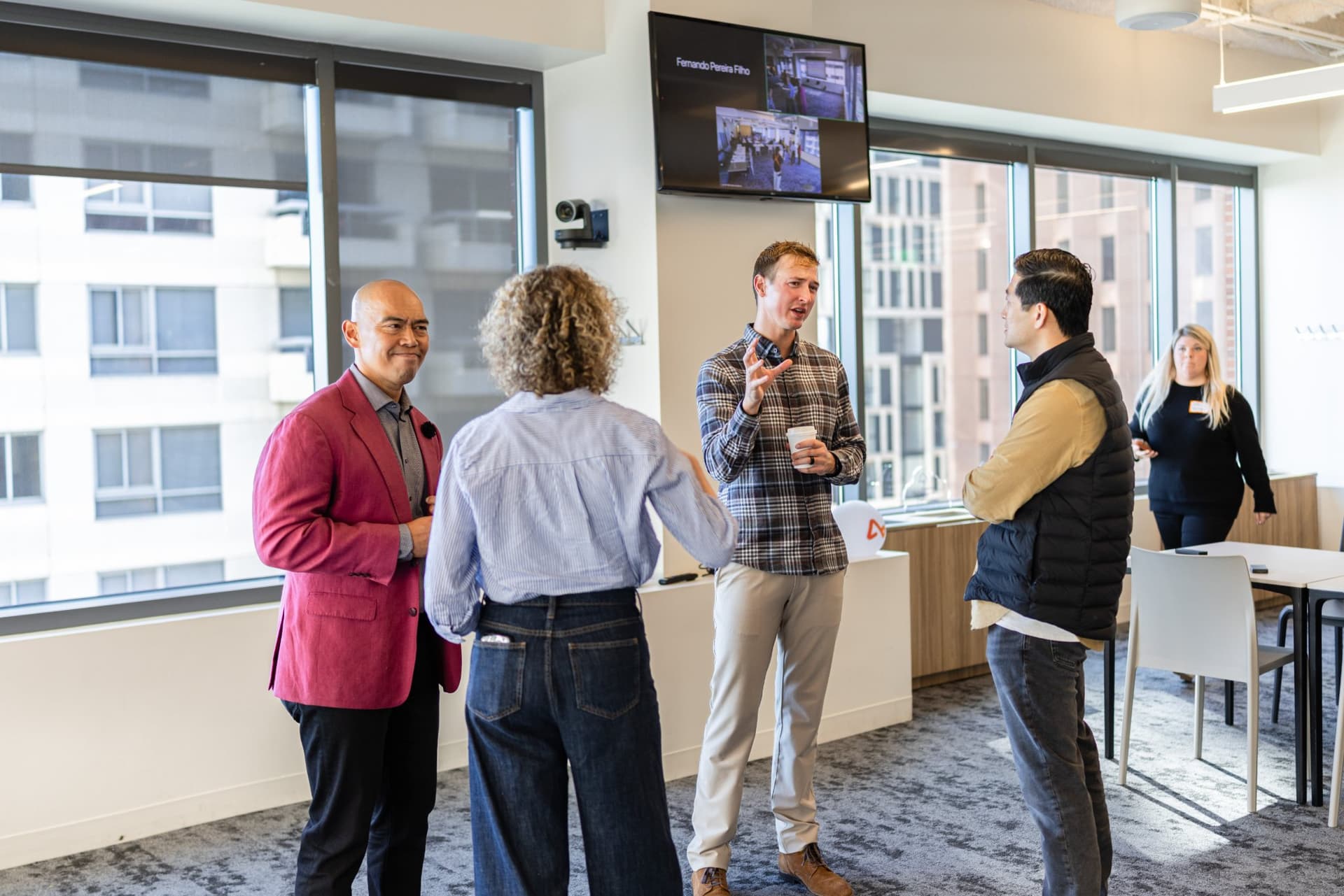 Dean Quiambao and Drew Armanino networking with finance leaders at Airwallex's Beyond the Hype: AI and the Future of Finance breakfast fireside chat at the Airwallex San Francisco office by JY Studio