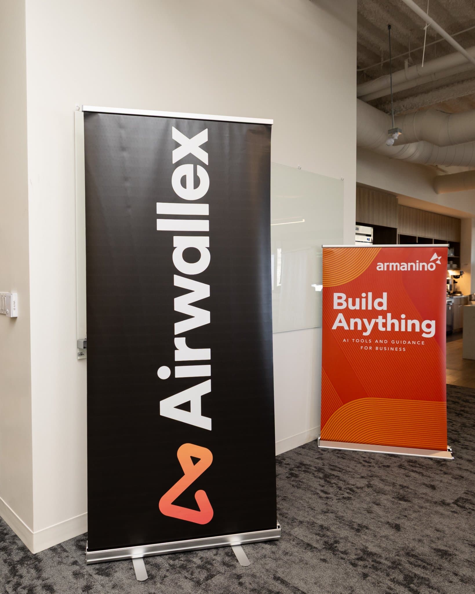 Airwallex and Armanino Build Anything banners at the event entrance at Airwallex's Beyond the Hype: AI and the Future of Finance breakfast fireside chat at the Airwallex San Francisco office by JY Studio