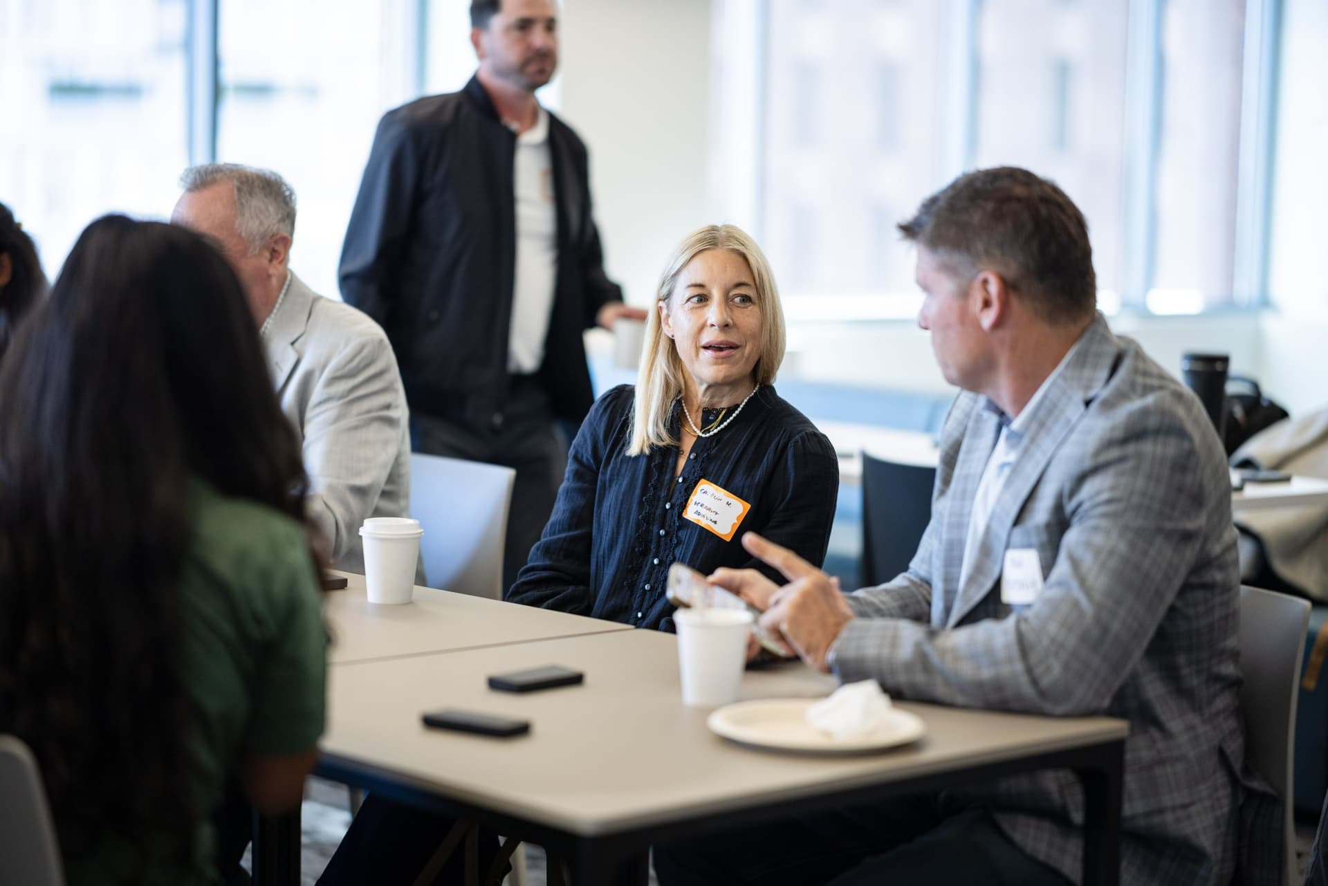 Finance executives talking at a table during the peer exchange at Airwallex's Beyond the Hype: AI and the Future of Finance breakfast fireside chat at the Airwallex San Francisco office by JY Studio
