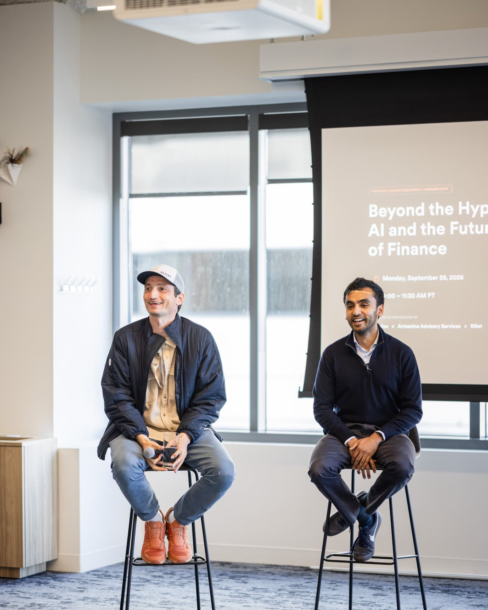Nicolas Kopp and Pranav Sood smiling on stage before the fireside chat at Airwallex's Beyond the Hype: AI and the Future of Finance breakfast fireside chat at the Airwallex San Francisco office by JY Studio