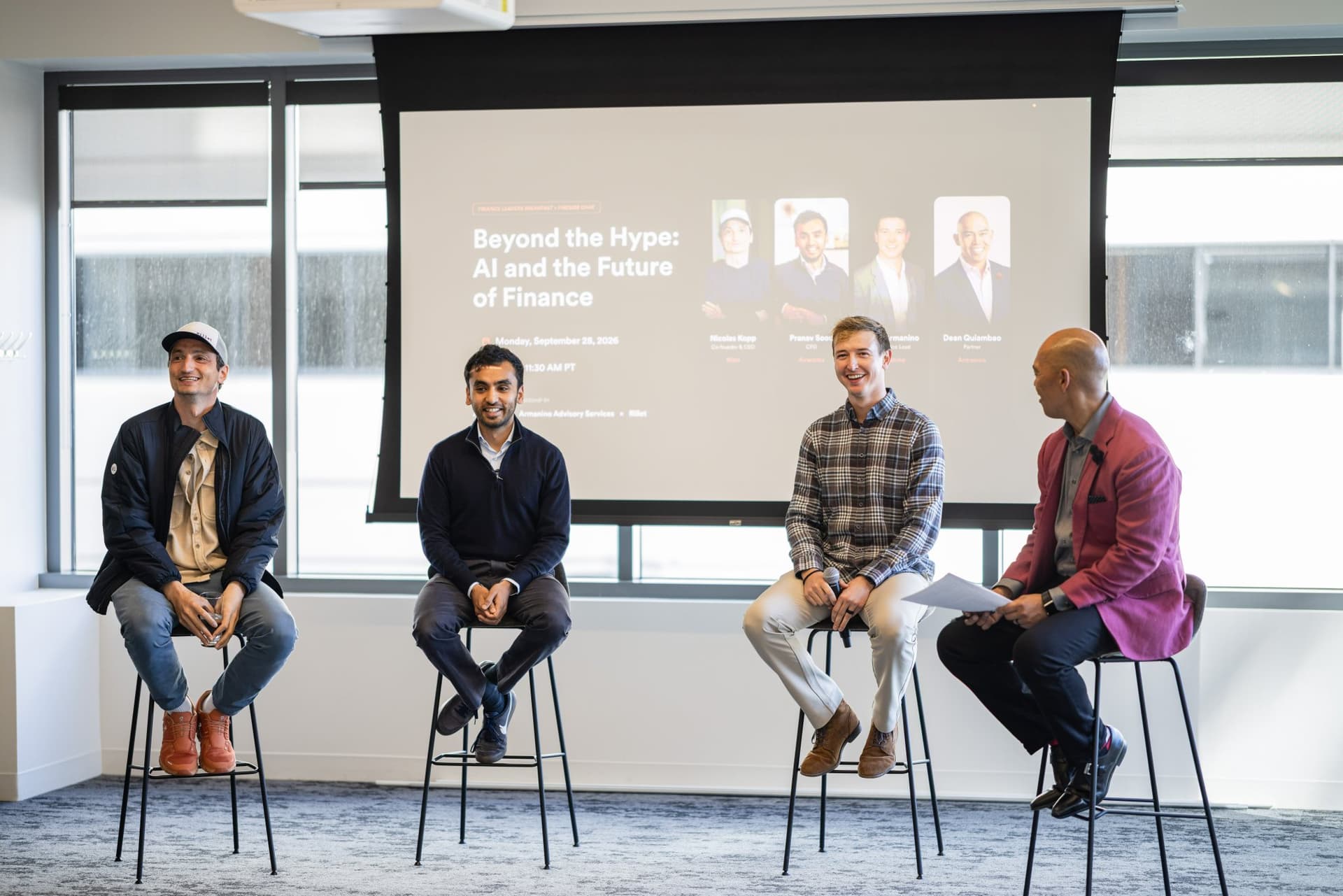 Panelists laughing together on stage under the Beyond the Hype slide at Airwallex's Beyond the Hype: AI and the Future of Finance breakfast fireside chat at the Airwallex San Francisco office by JY Studio