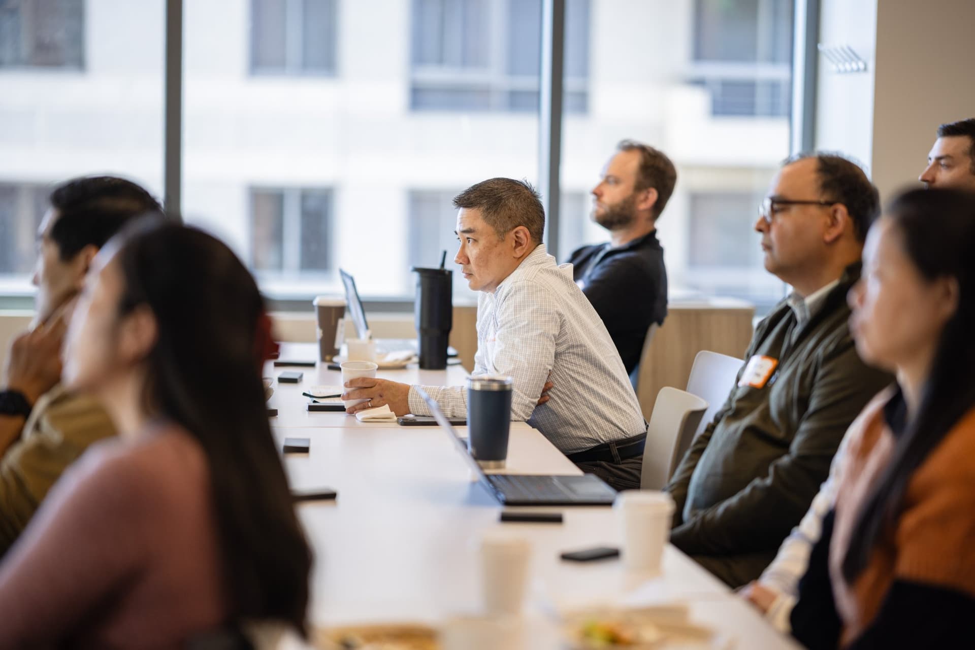 Side view of finance leaders following the discussion at Airwallex's Beyond the Hype: AI and the Future of Finance breakfast fireside chat at the Airwallex San Francisco office by JY Studio