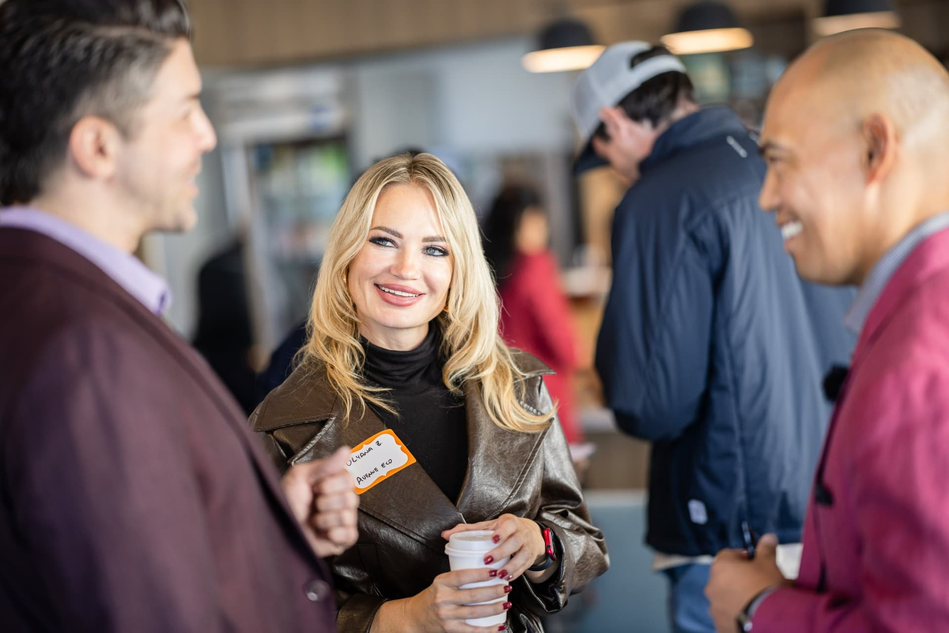 Dean Quiambao laughing with guests during networking at Airwallex's Beyond the Hype: AI and the Future of Finance breakfast fireside chat at the Airwallex San Francisco office by JY Studio