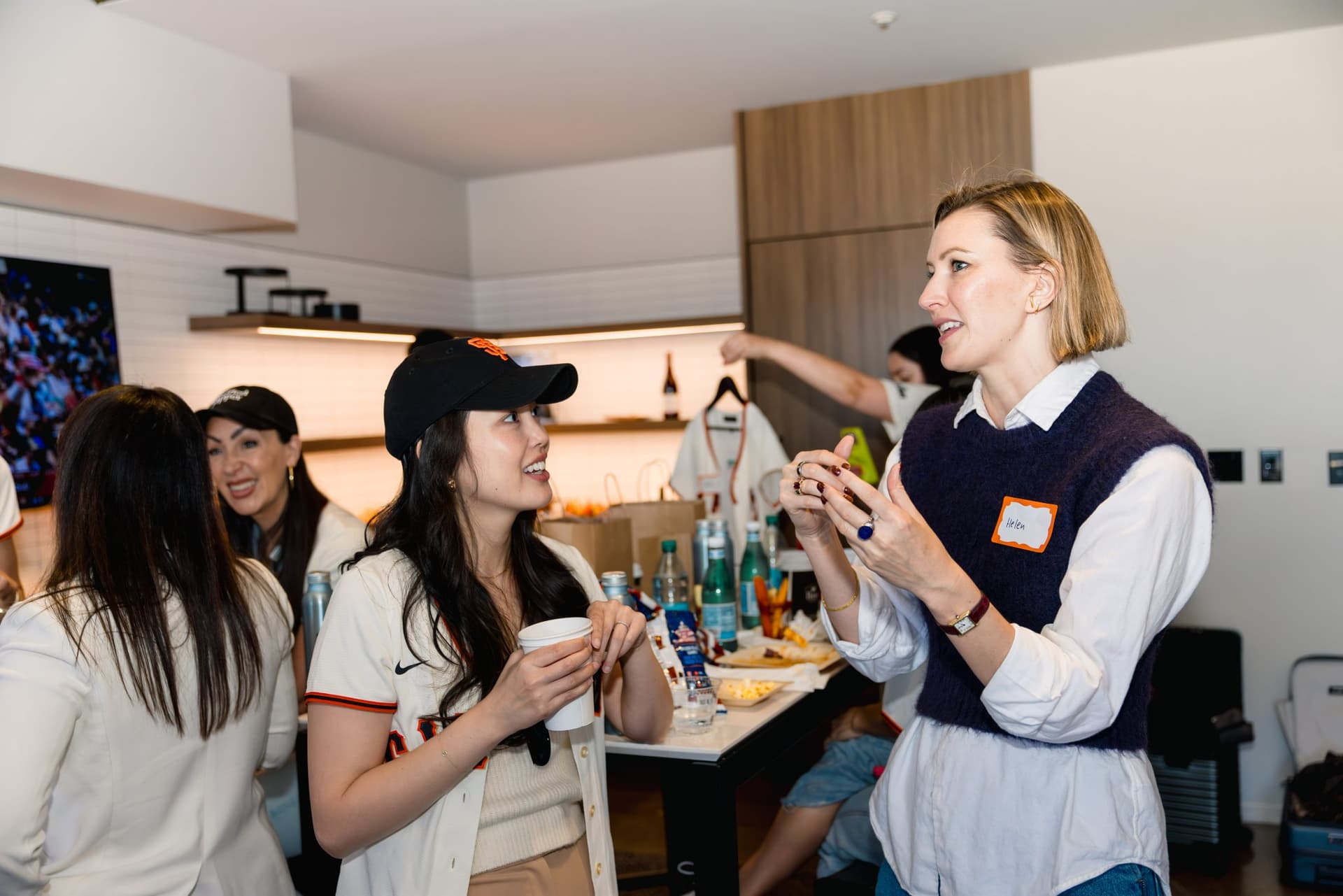Guests toasting during the Airwallex suite celebration at Oracle Park in San Francisco by JY Studio