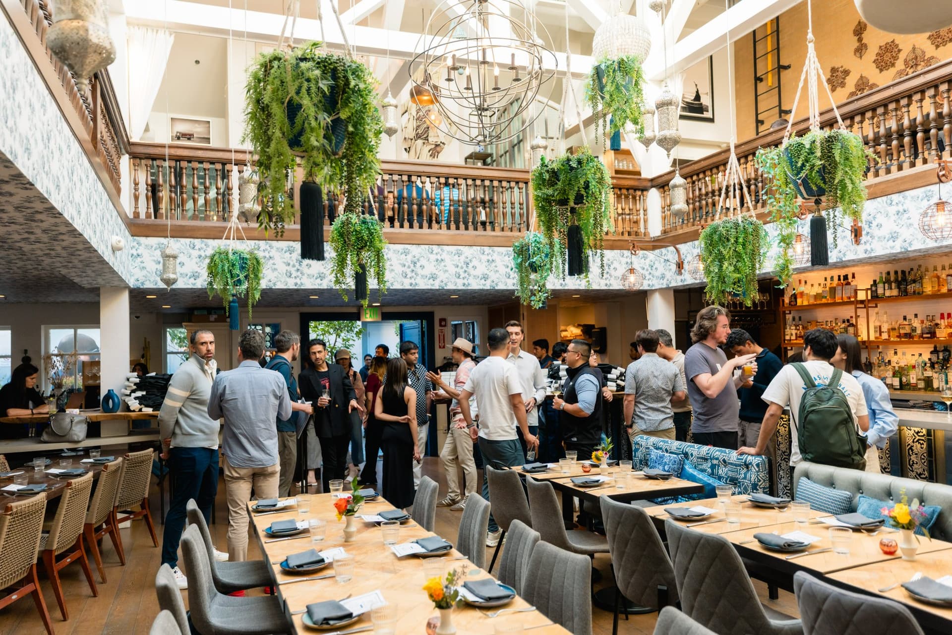 Builders and researchers engaged in conversation during the Apollo AI Accelerator mixer in Los Altos, Silicon Valley by JY Studio