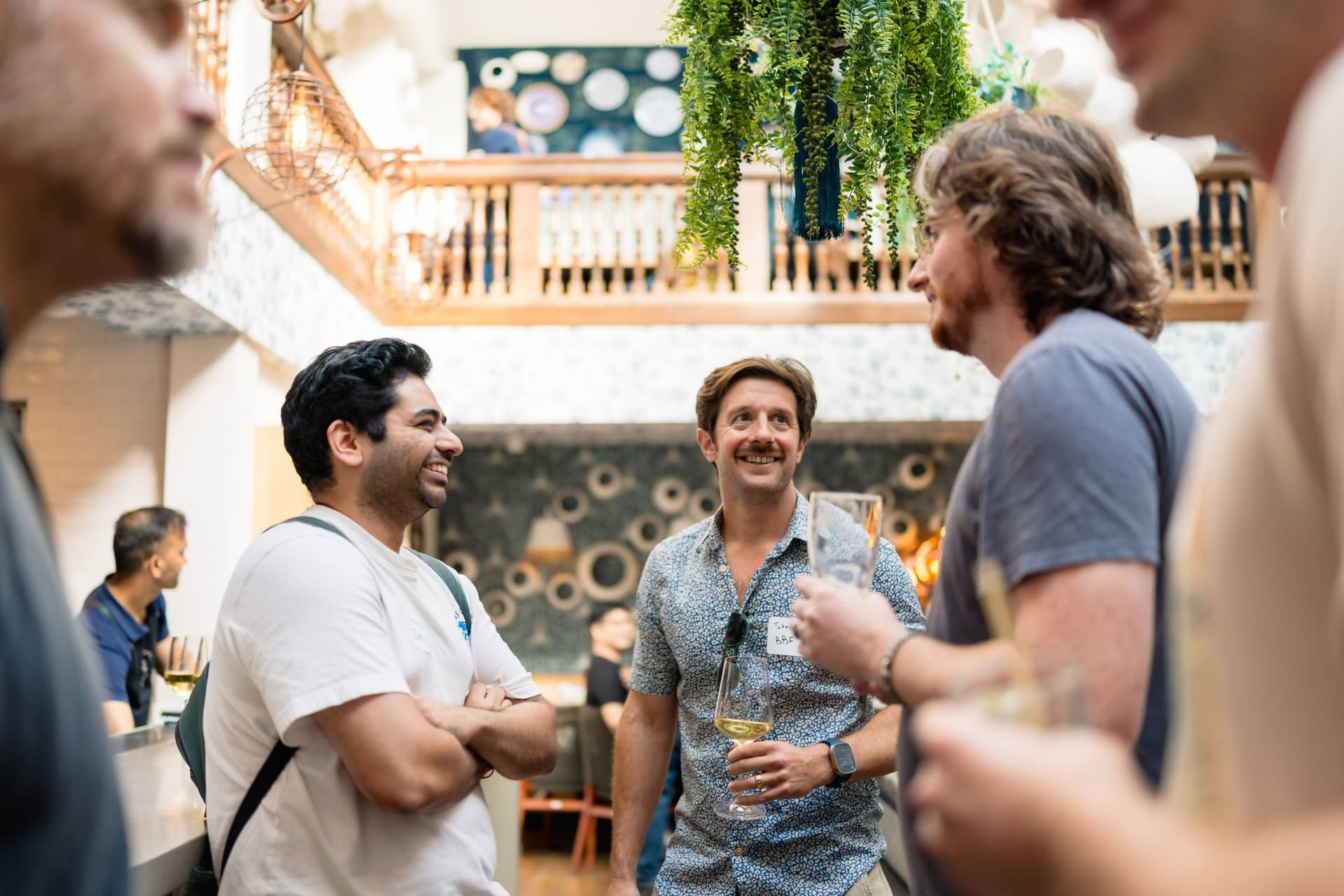 AI founders sharing a laugh at the Apollo AI Accelerator mixer in Los Altos, Bay Area by JY Studio