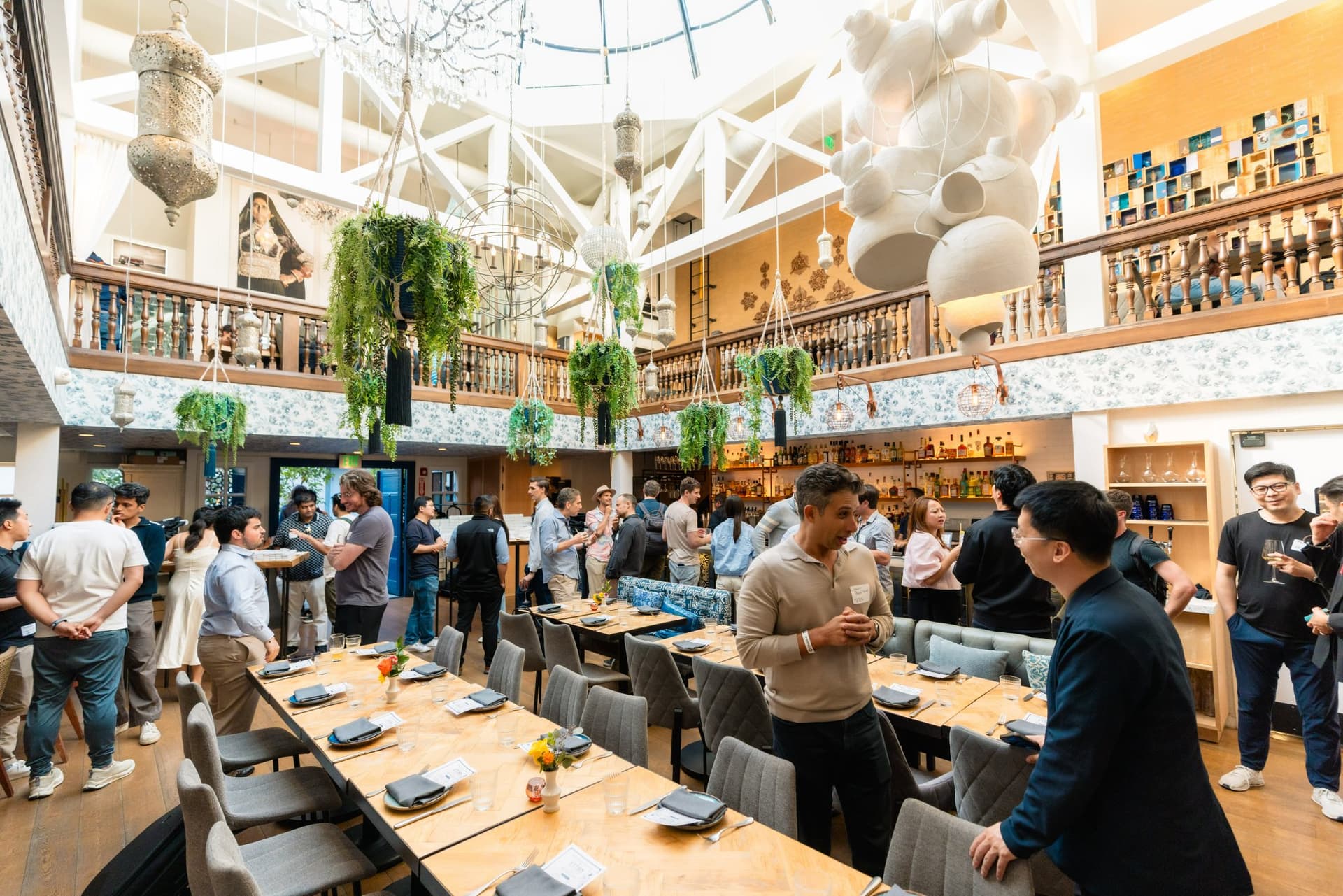 Guests and mentors connecting in small groups at the Apollo AI Accelerator reception in Los Altos, Silicon Valley by JY Studio