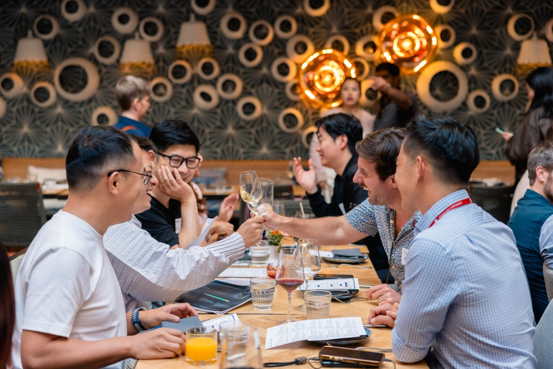 Engineers and researchers toasting drinks at the Apollo AI Accelerator networking event in Los Altos by JY Studio