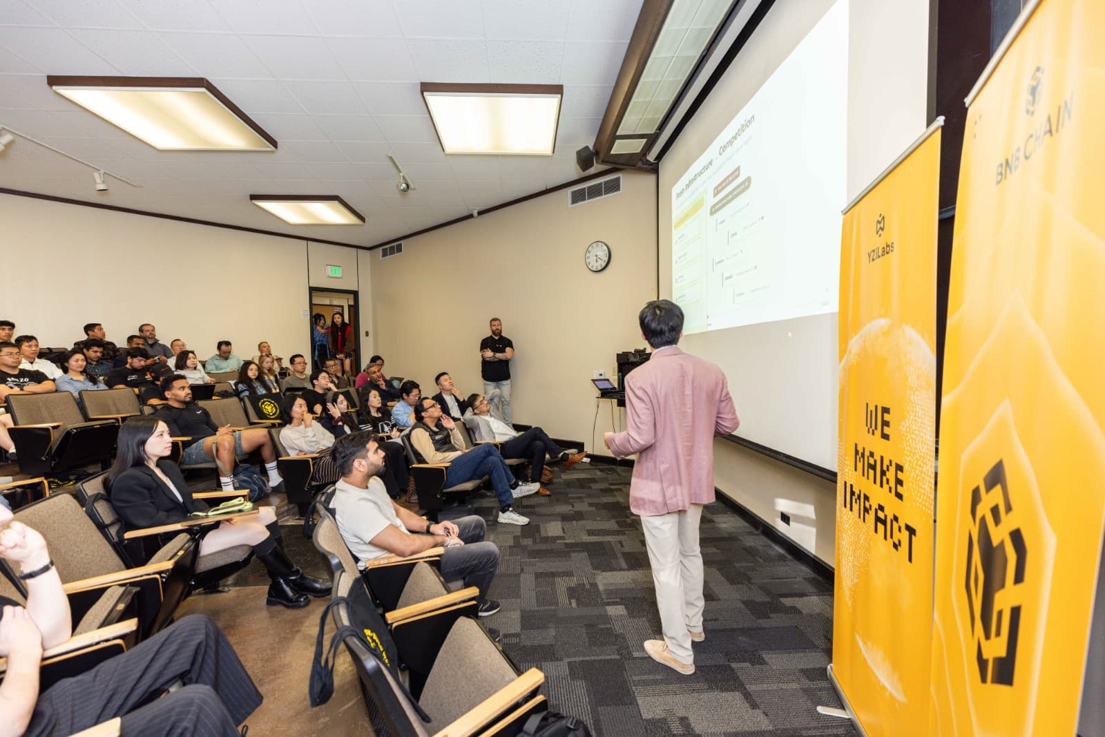 Candid shot of attendees engaging with Web3 exhibits at BNB Chain Stanford event by JY Studio