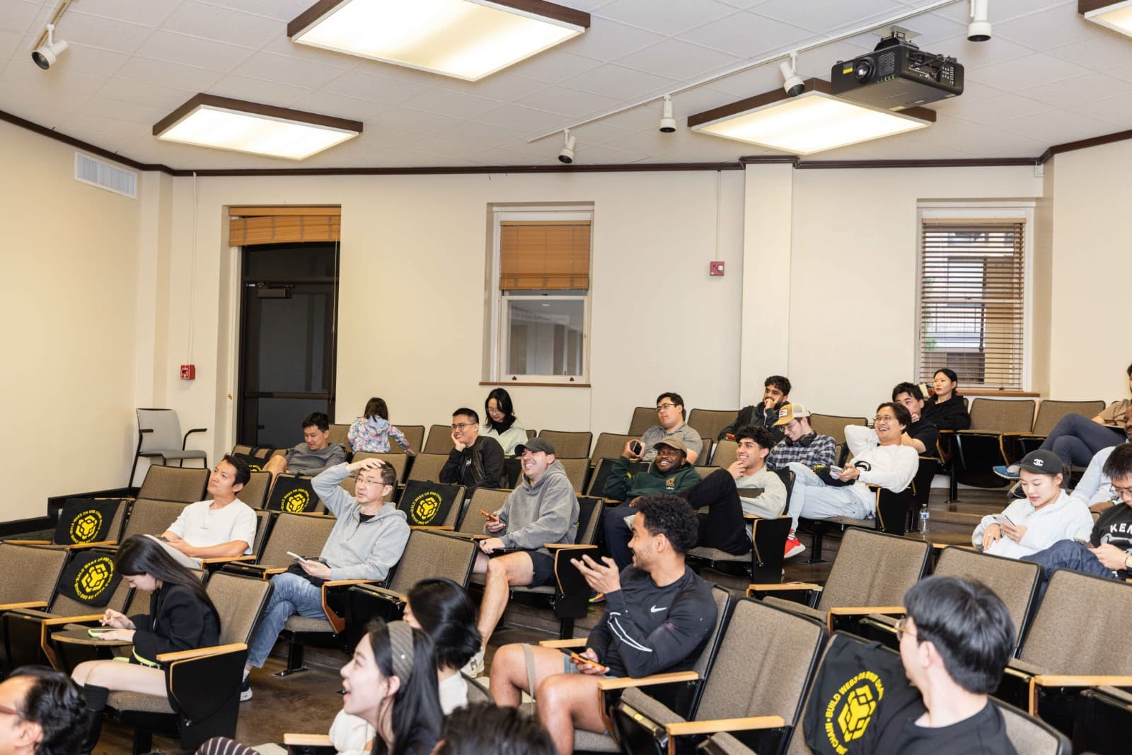 Engaged crowd listening to blockchain research talk at BNB Chain Stanford event by JY Studio