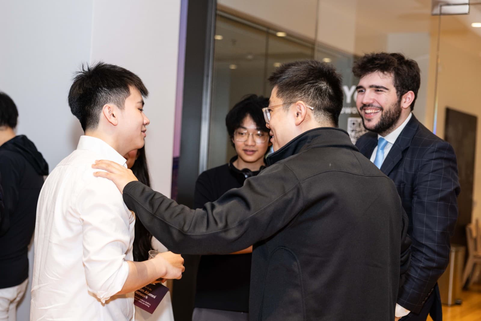 Candid group conversation captured at Crimson Alumni Network event at Yes SF by JY Studio