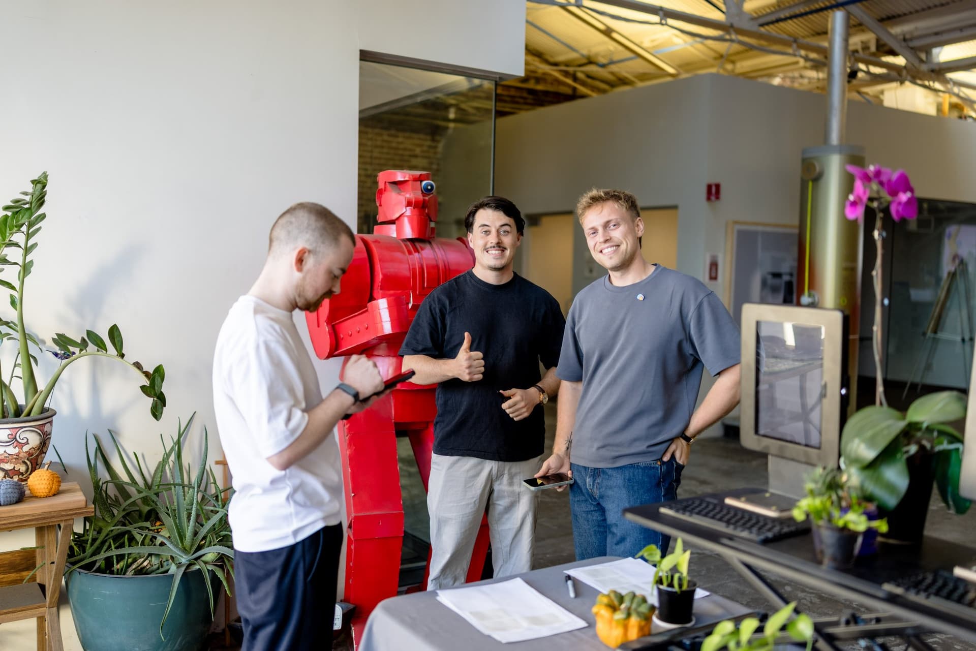 Guests arriving beside the red robot sculpture at check-in at Clay's Breaking the Mold community networking event during SF Tech Week 2026 in San Francisco by JY Studio