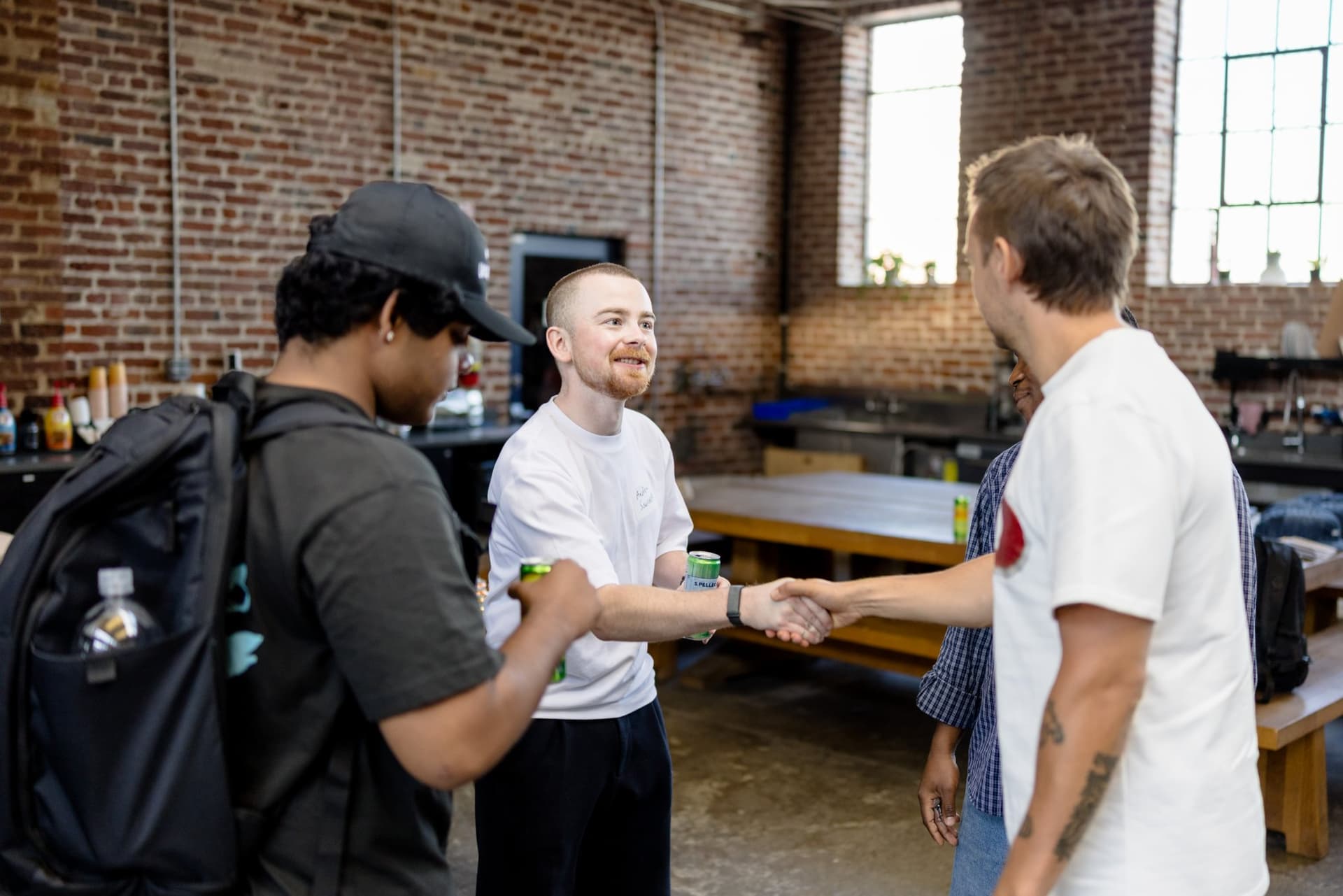 Guests shaking hands as they meet during the welcome mingle at Clay's Breaking the Mold community networking event during SF Tech Week 2026 in San Francisco by JY Studio