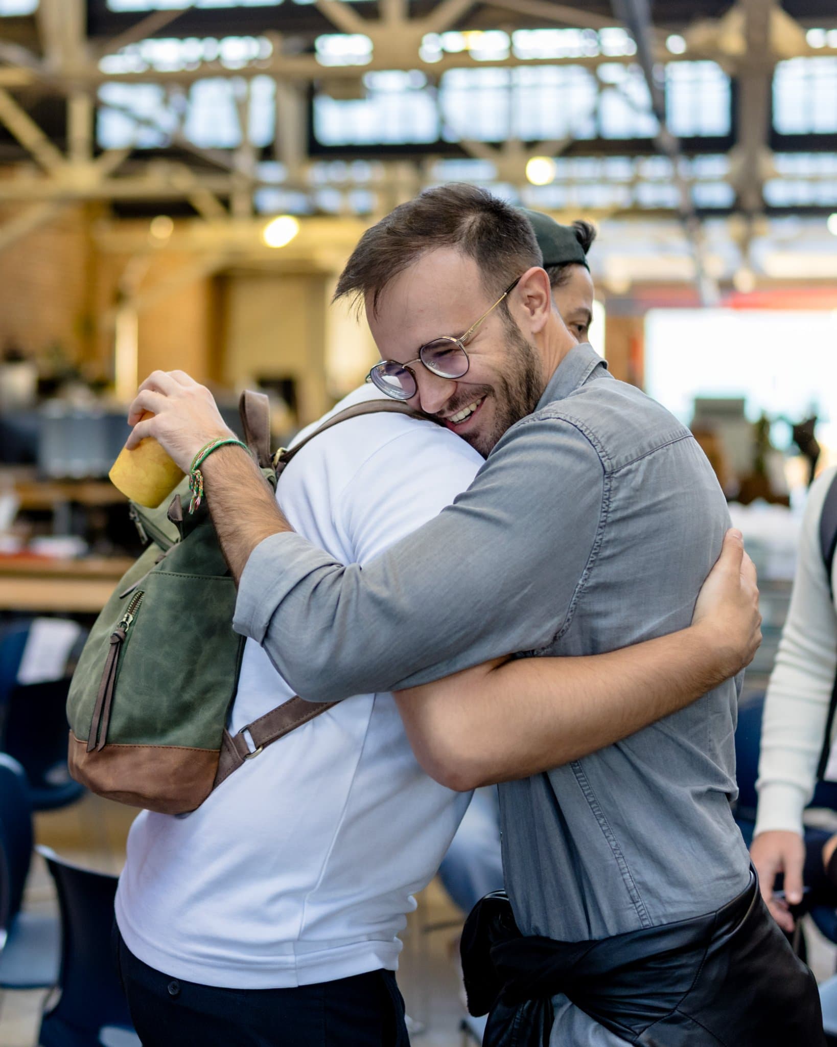 Two Clay Club members sharing a big hug on arrival at Clay's Breaking the Mold community networking event during SF Tech Week 2026 in San Francisco by JY Studio
