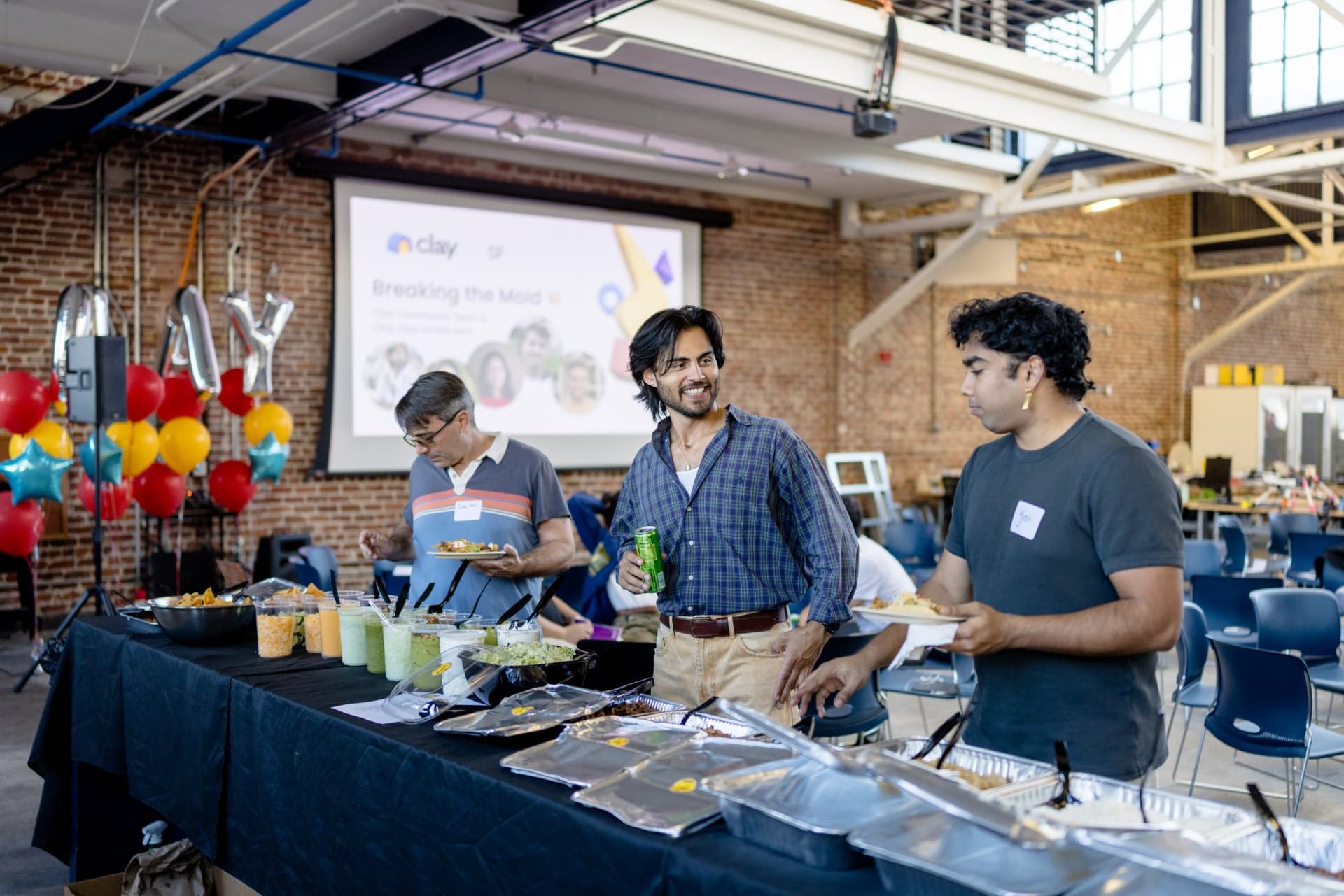 Guests serving themselves from the dinner buffet at Clay's Breaking the Mold community networking event during SF Tech Week 2026 in San Francisco by JY Studio
