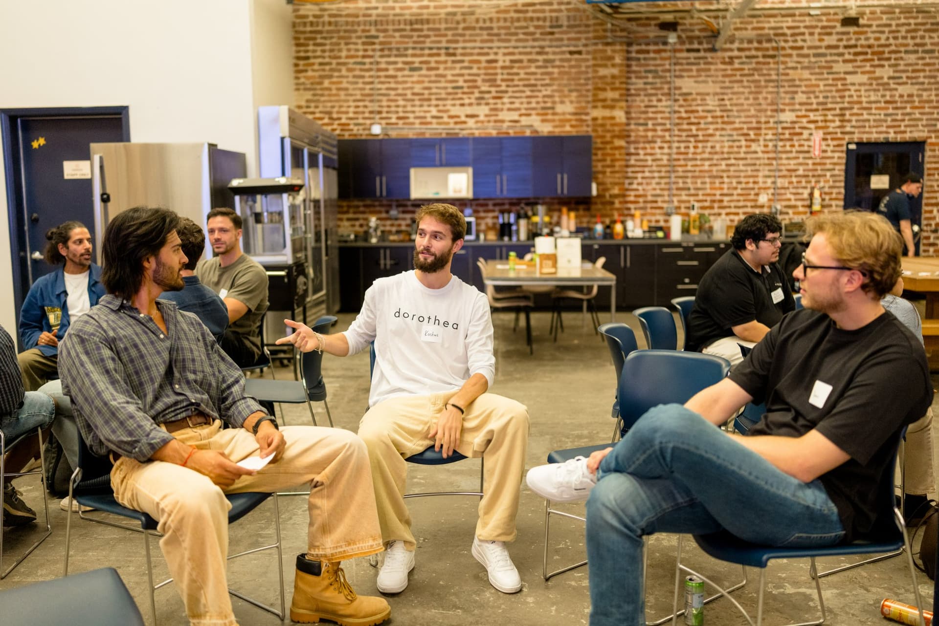 Small-group conversation circle near the makerspace kitchen at Clay's Breaking the Mold community networking event during SF Tech Week 2026 in San Francisco by JY Studio