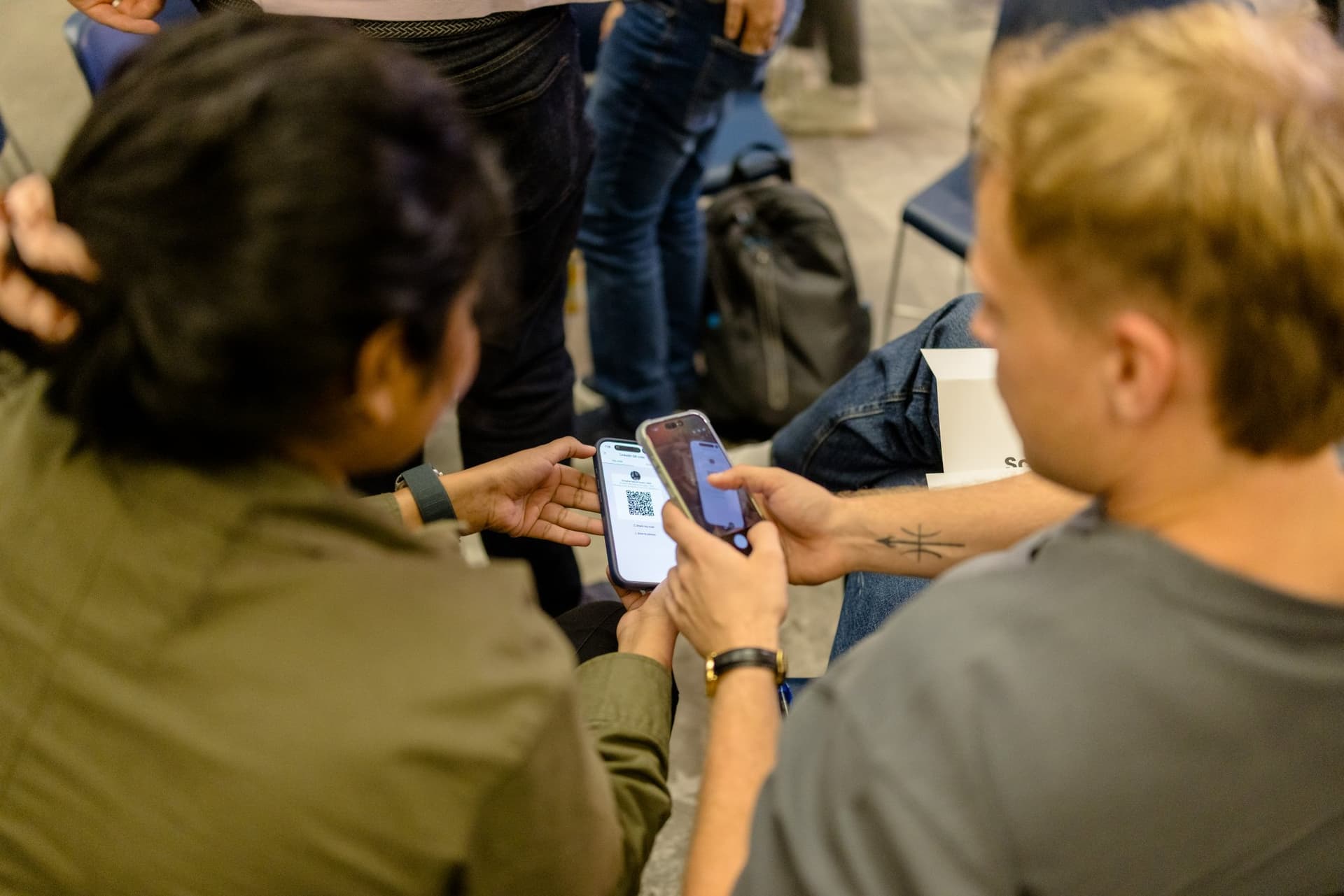Attendees scanning QR codes to swap contacts at Clay's Breaking the Mold community networking event during SF Tech Week 2026 in San Francisco by JY Studio