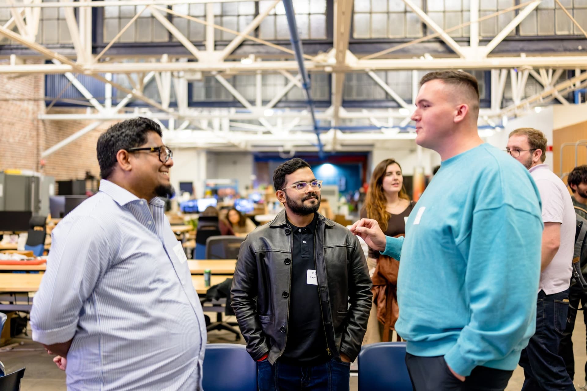Three guests talking in the makerspace workshop area at Clay's Breaking the Mold community networking event during SF Tech Week 2026 in San Francisco by JY Studio