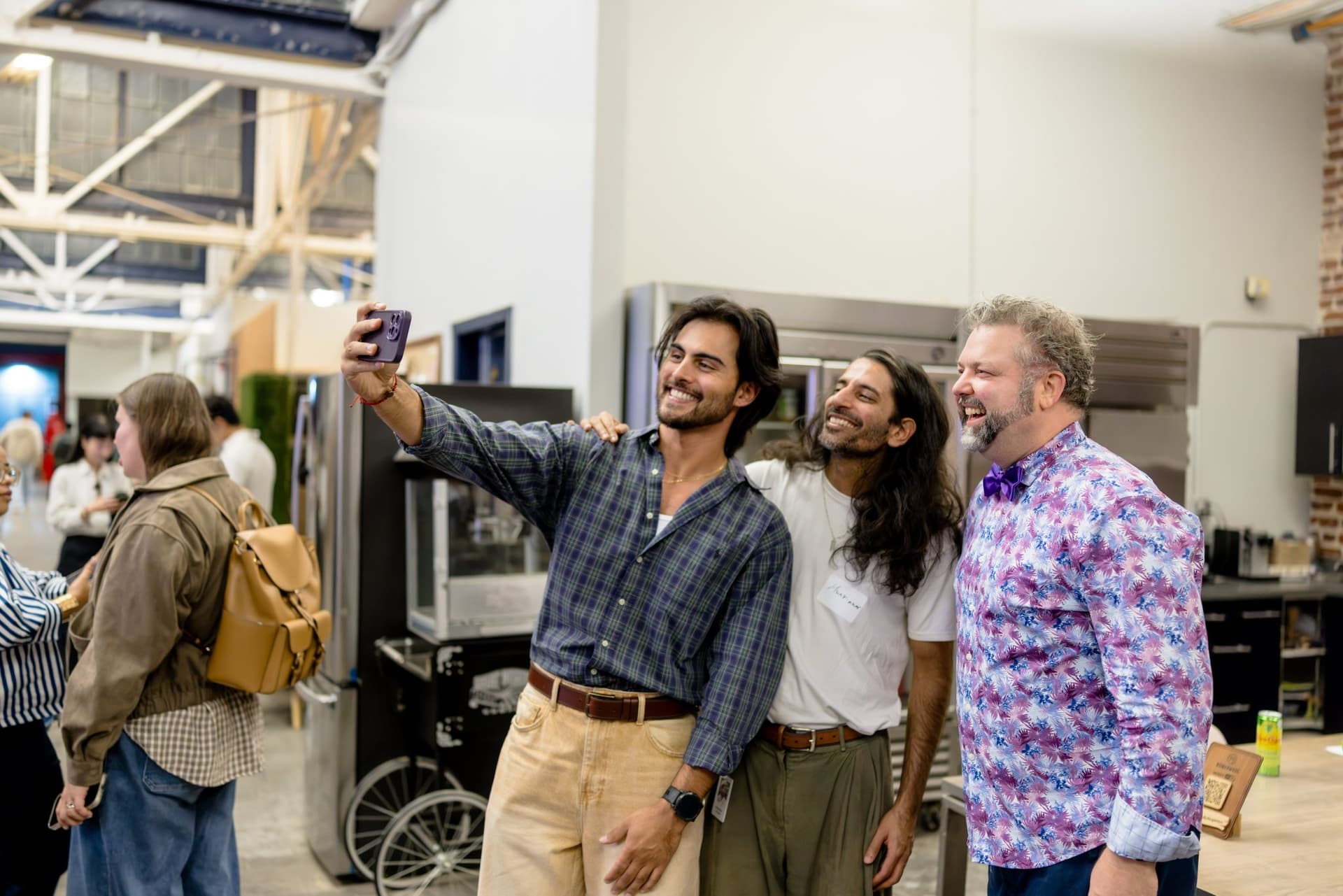 Three new friends taking a selfie together at Clay's Breaking the Mold community networking event during SF Tech Week 2026 in San Francisco by JY Studio