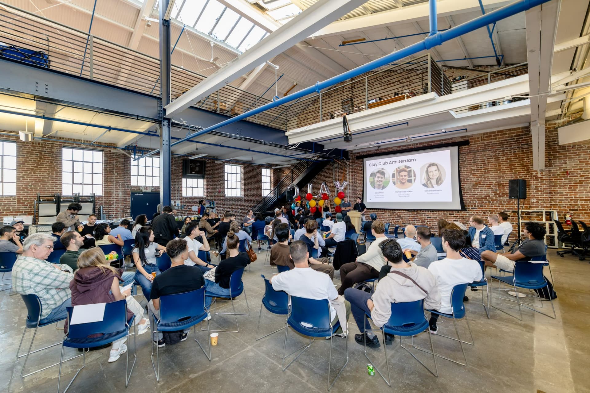 Full room of chairs gathered for the Clay Club Amsterdam session at Clay's Breaking the Mold community networking event during SF Tech Week 2026 in San Francisco by JY Studio