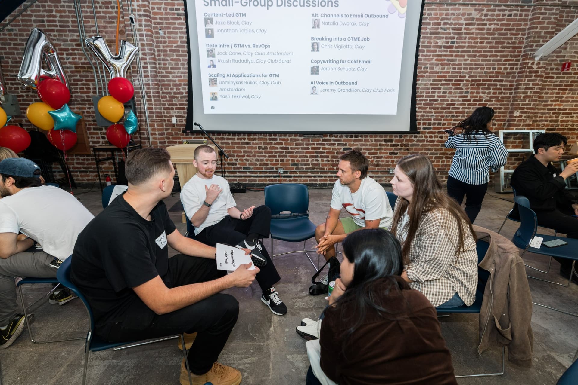Small-group discussion topics on screen for GTM engineering, outbound, and cold email at Clay's Breaking the Mold community networking event during SF Tech Week 2026 in San Francisco by JY Studio