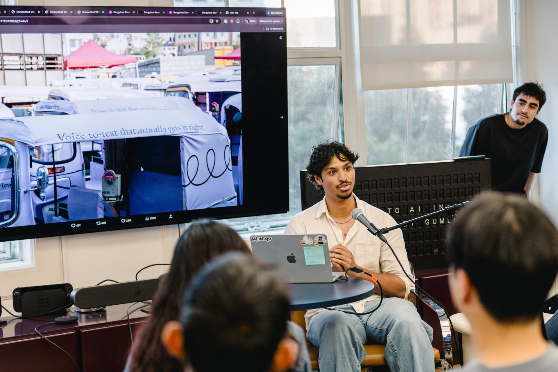 Guest speaker introducing himself at the microphone during the Gumloop AI in Marketing session in San Francisco