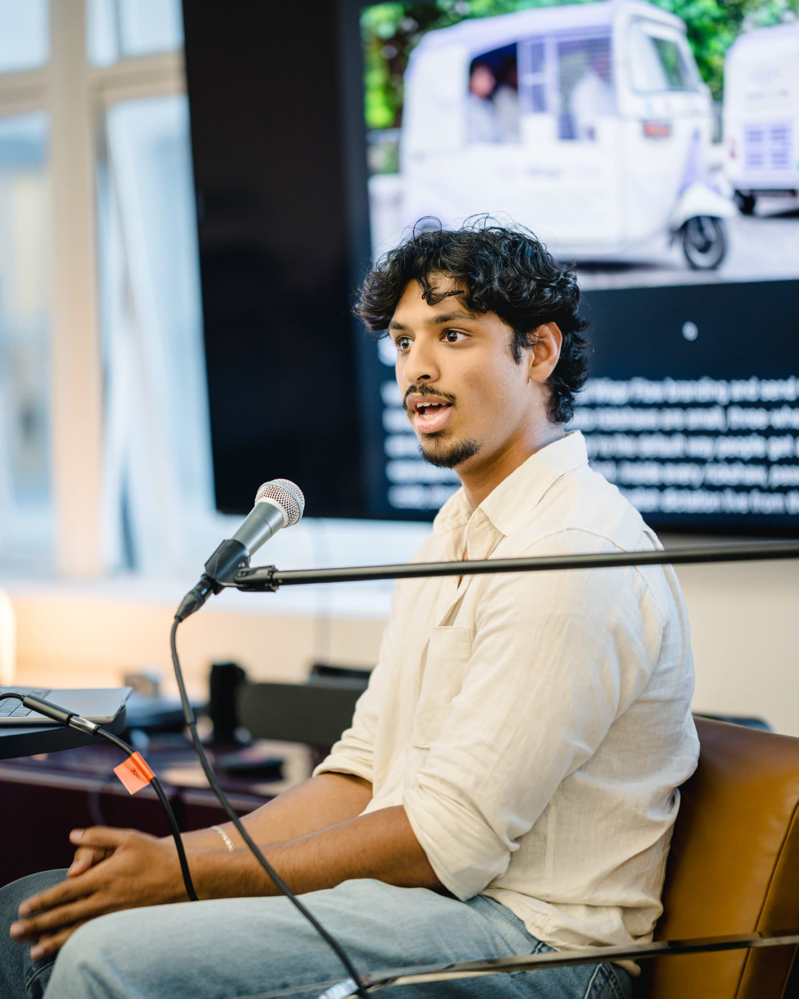Fireside chat guest speaker answering questions on AI marketing agents at Gumloop's San Francisco office