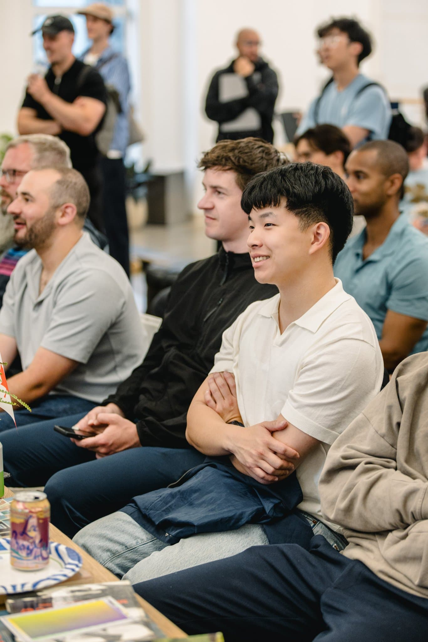 Attendees smiling and engaged during the Gumloop "Agents in Actions" talk in San Francisco