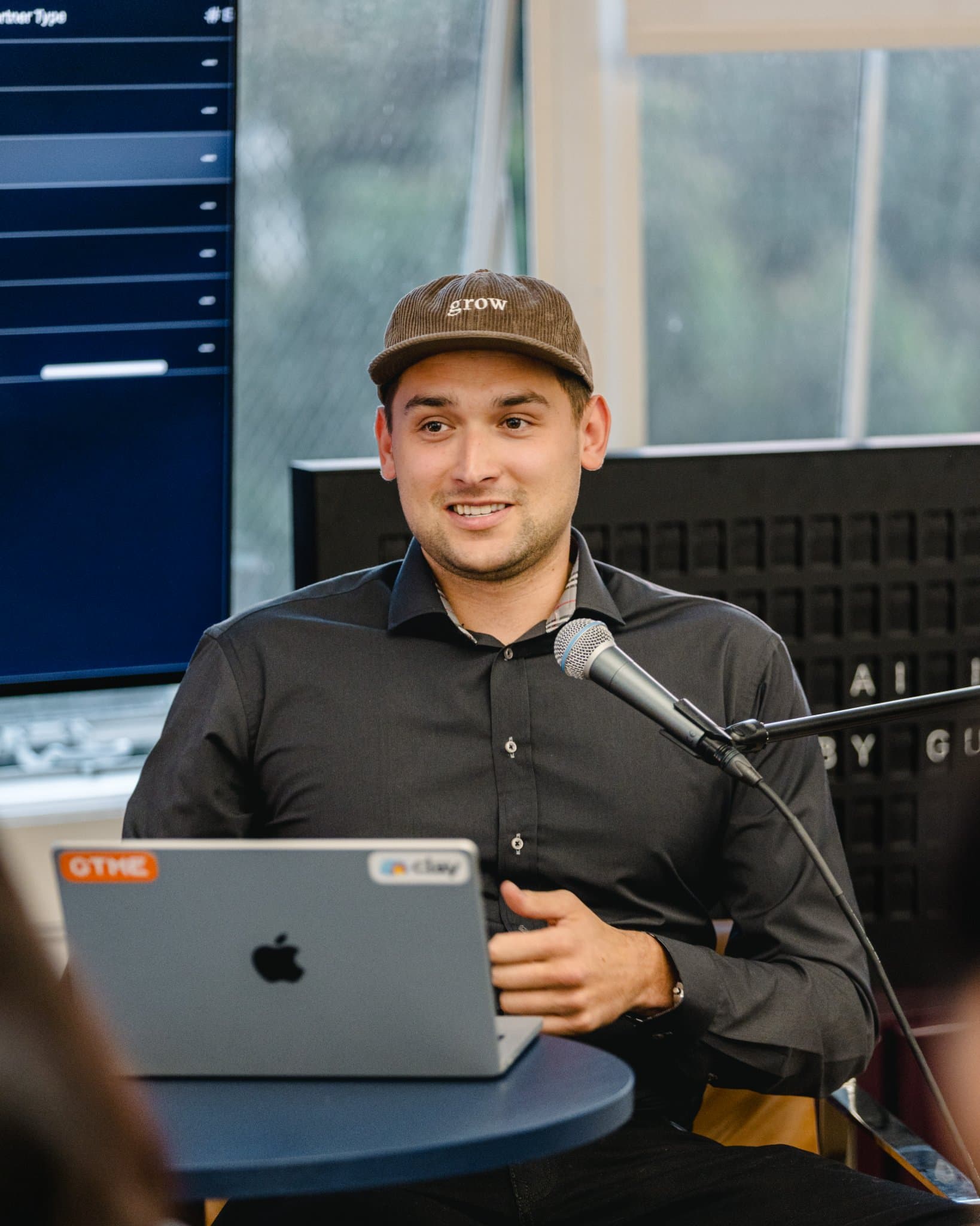 Attendee holding up a phone to record the speaker at the Gumloop San Francisco meetup