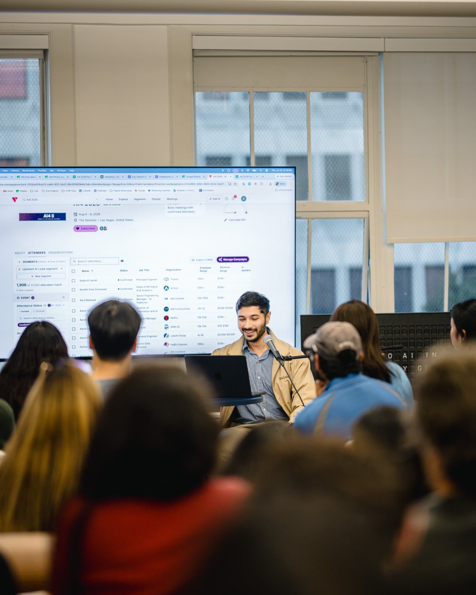 Speaker demonstrating an AI-powered lead and event attendee platform on screen at Gumloop's San Francisco office