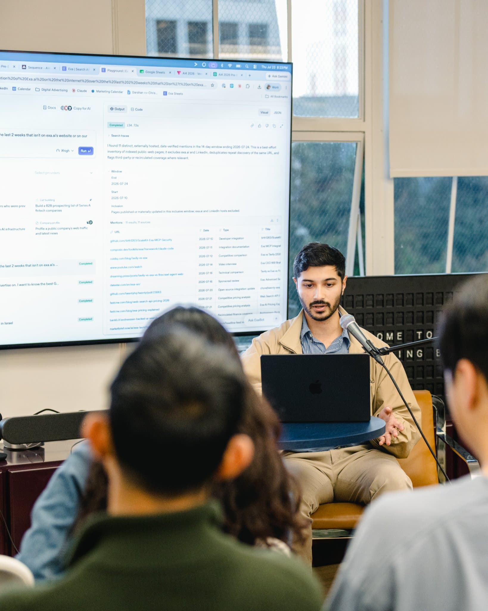 Presenter smiling while walking through a marketing analytics tool at the Gumloop meetup in San Francisco