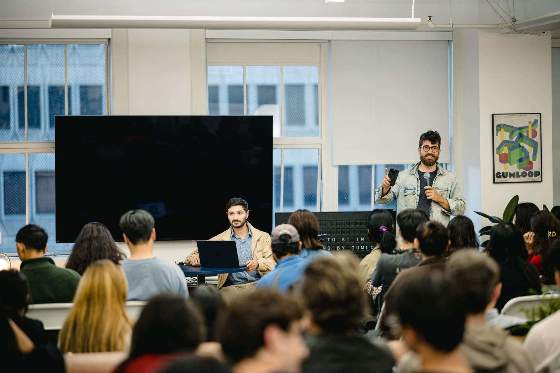 Guests watching a live demo of AI agents for sales outreach at Gumloop in San Francisco