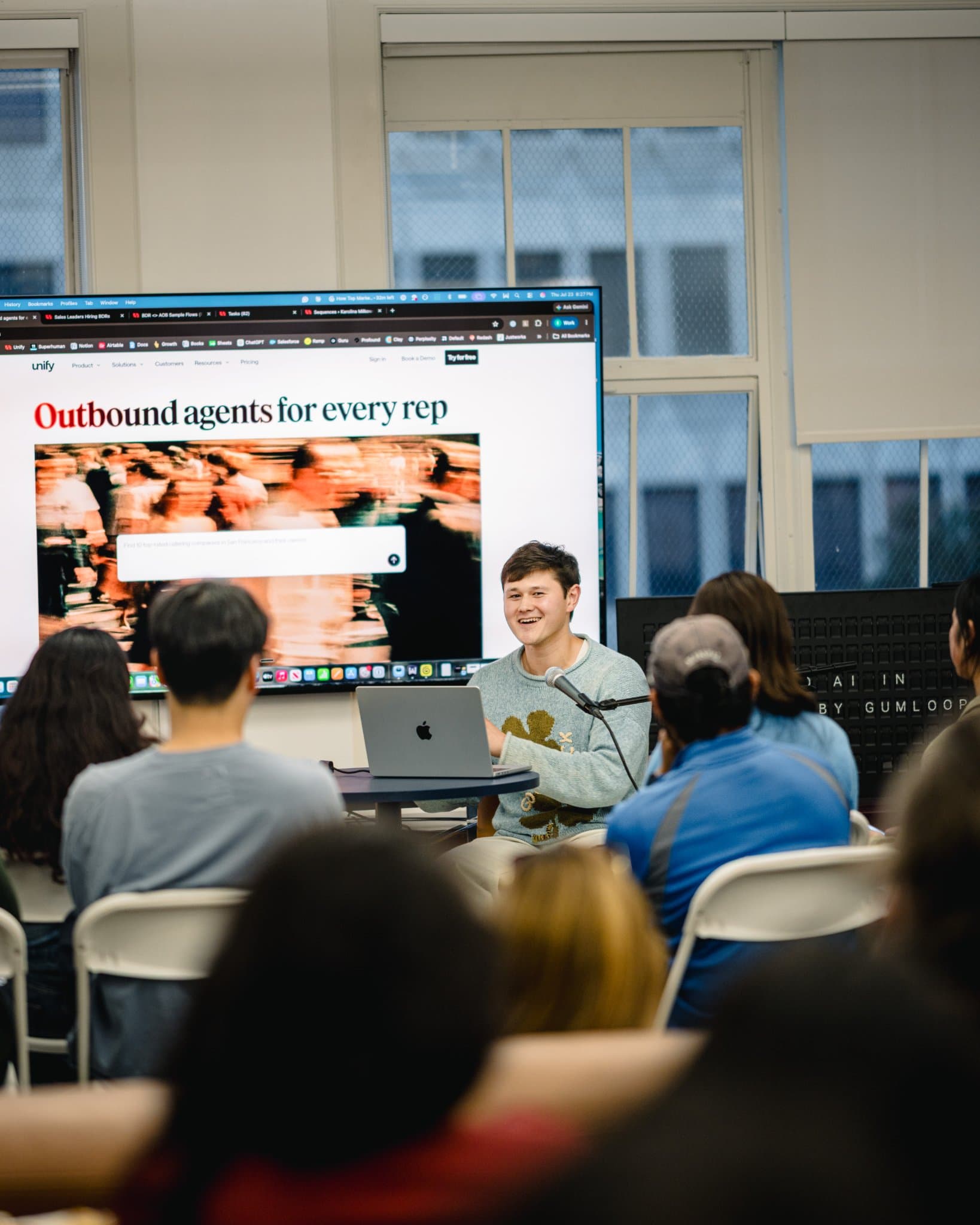 Attendees leaning in to watch the product walkthrough at the Gumloop AI in Marketing event