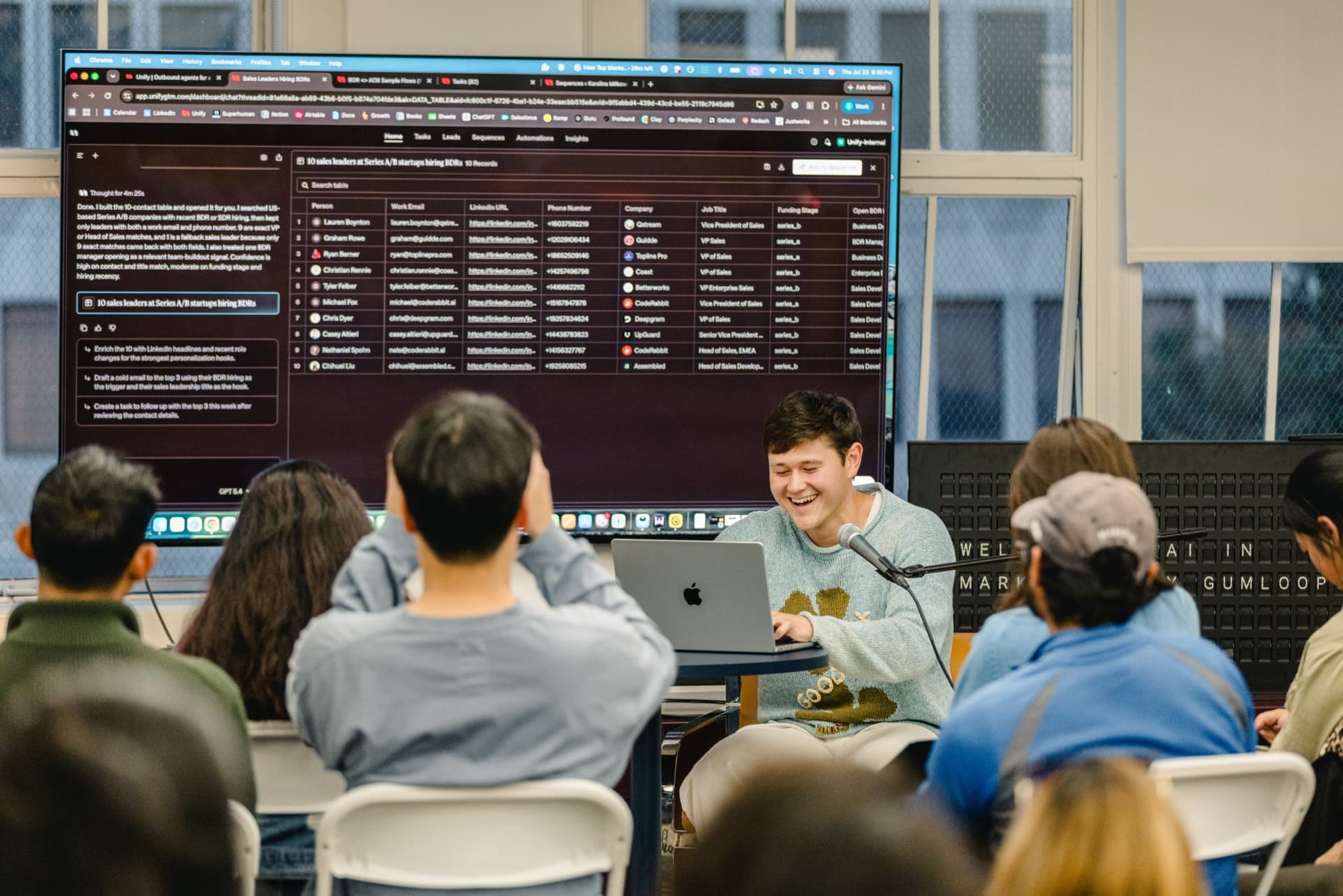 Audience members on their laptops following the outbound agent demo at Gumloop in San Francisco