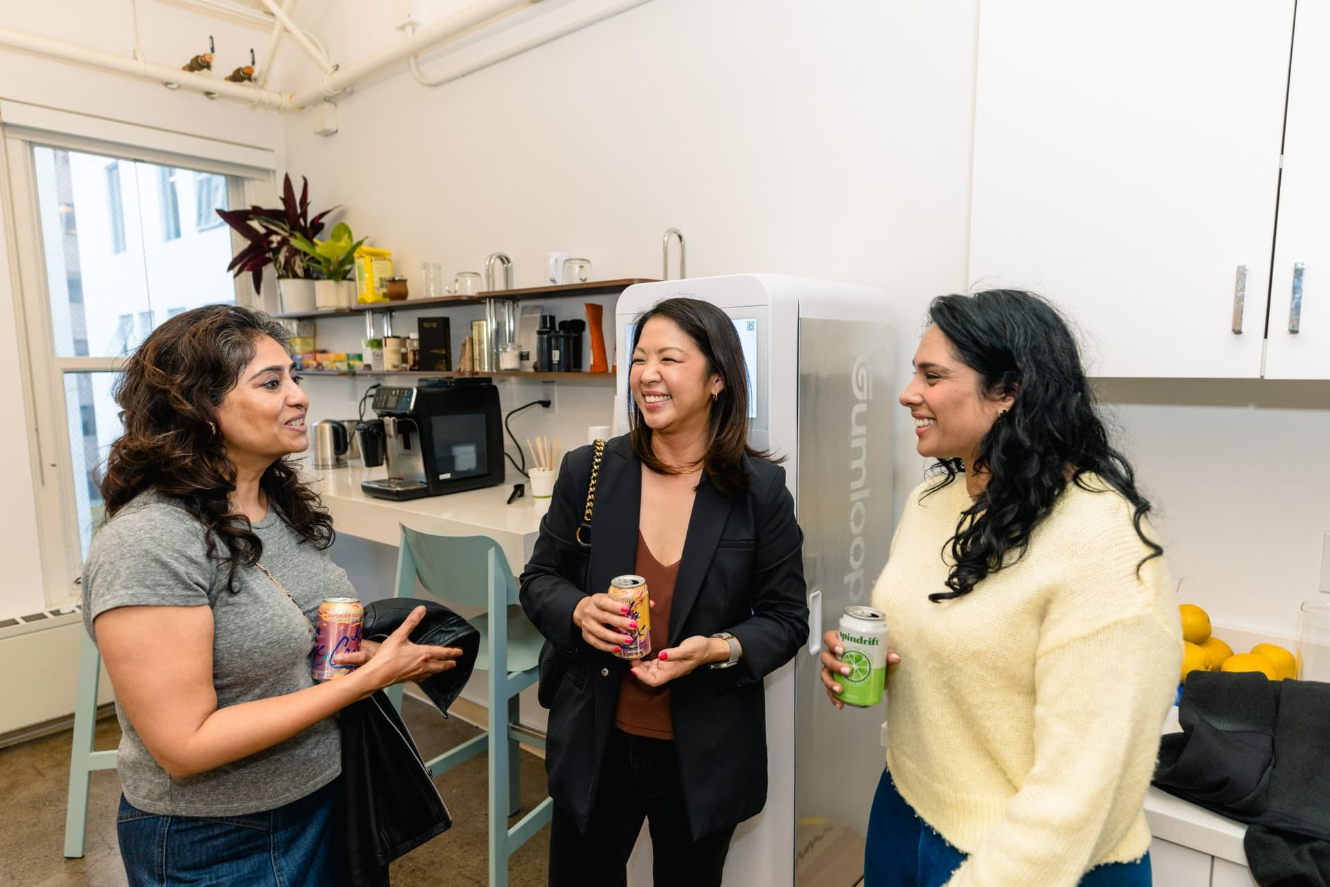 Attendee holding a plate of snacks while listening to the panel at Gumloop's San Francisco office