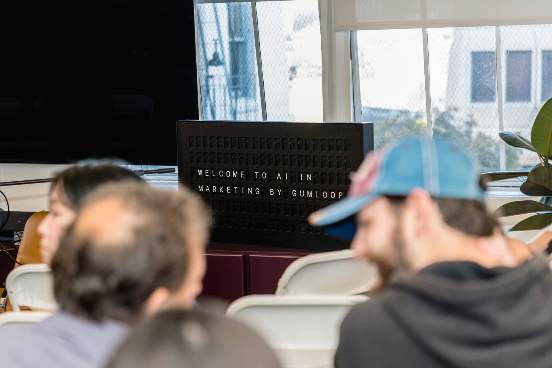 Speaker laughing with the audience during a candid moment at the Gumloop meetup in San Francisco