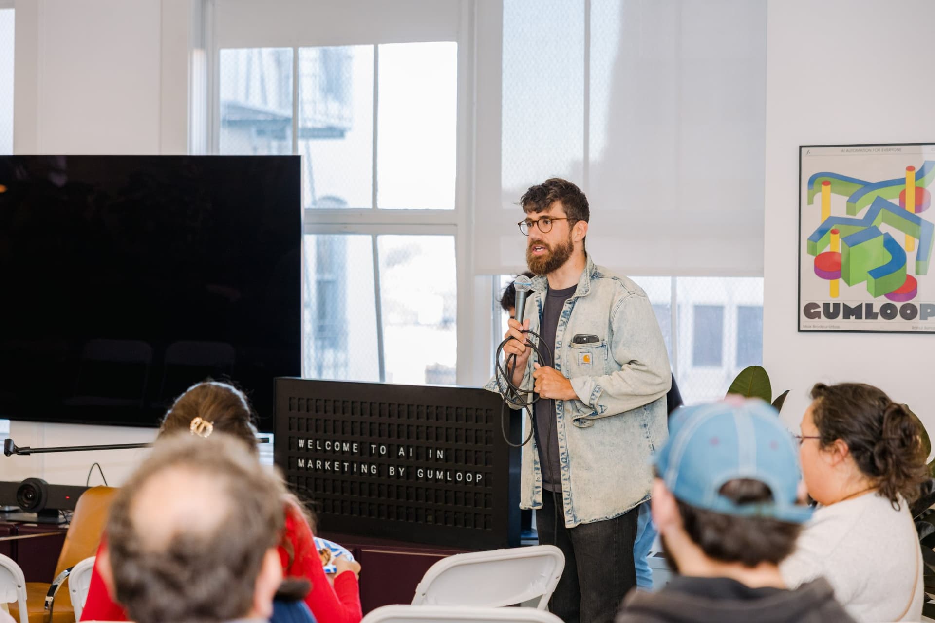 Guest checking notes on a phone during the Gumloop marketing meetup in San Francisco