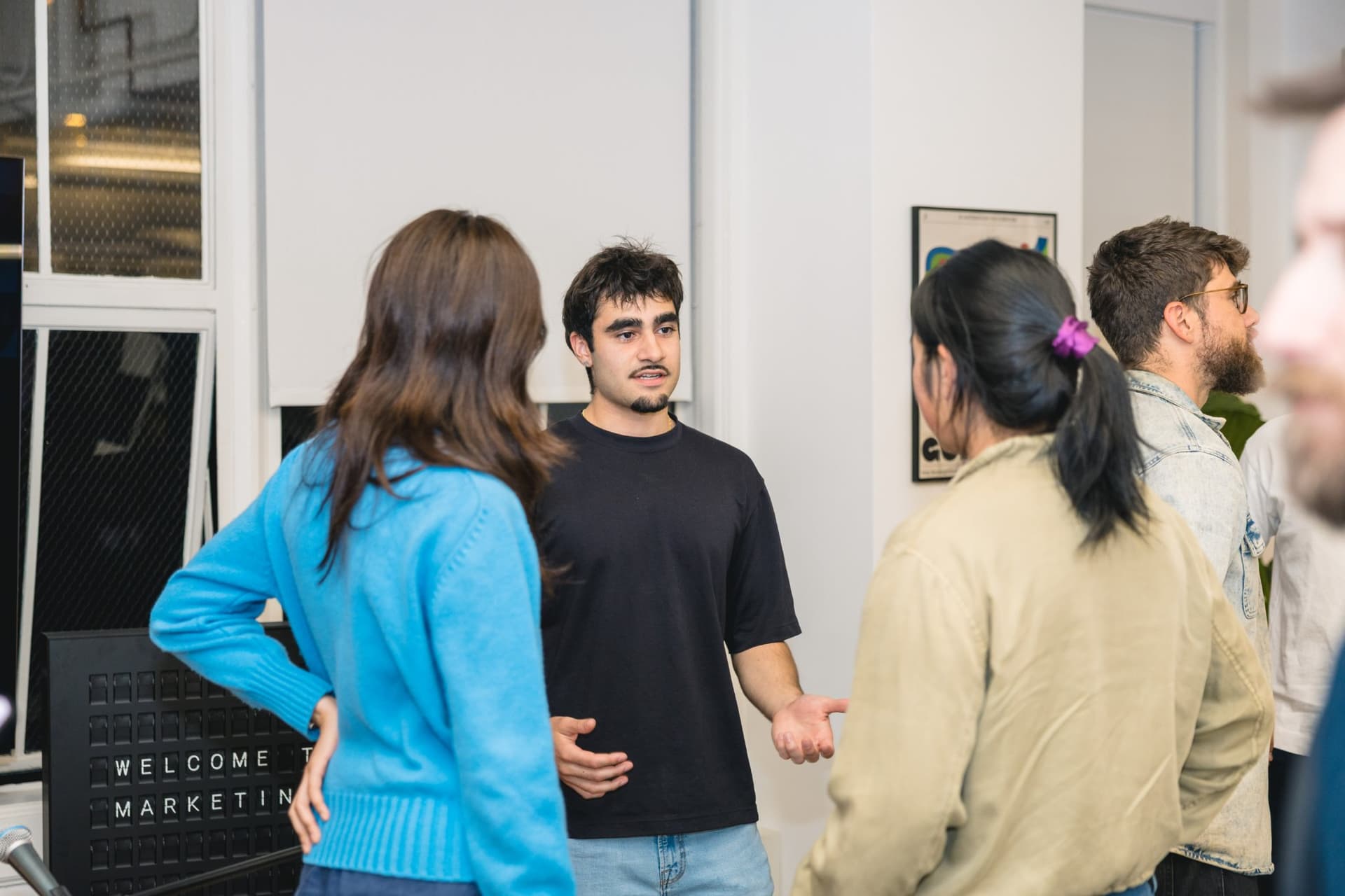 Candid conversation between guests during the networking portion of the Gumloop meetup in San Francisco