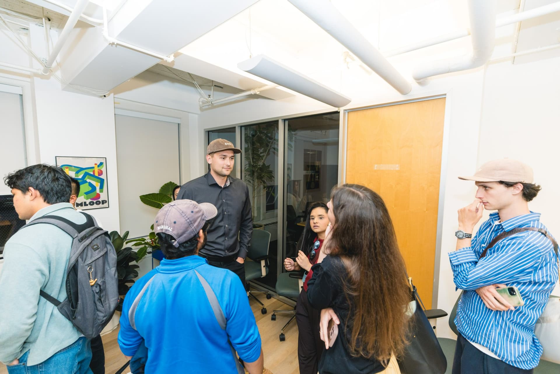 Attendees laughing together during post-event networking at Gumloop in San Francisco